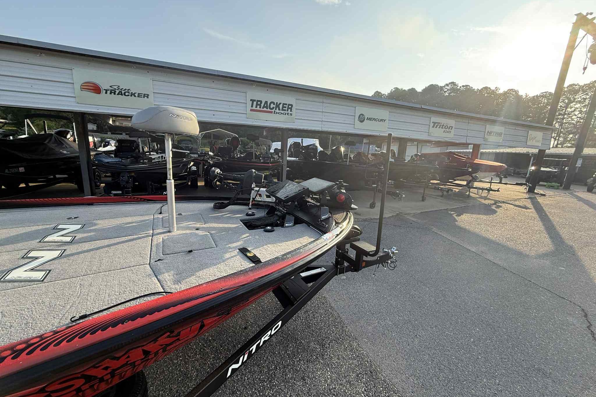 2022 Nitro Z21 XL Pro boat displayed at a dealership with Tracker and Mercury signage.