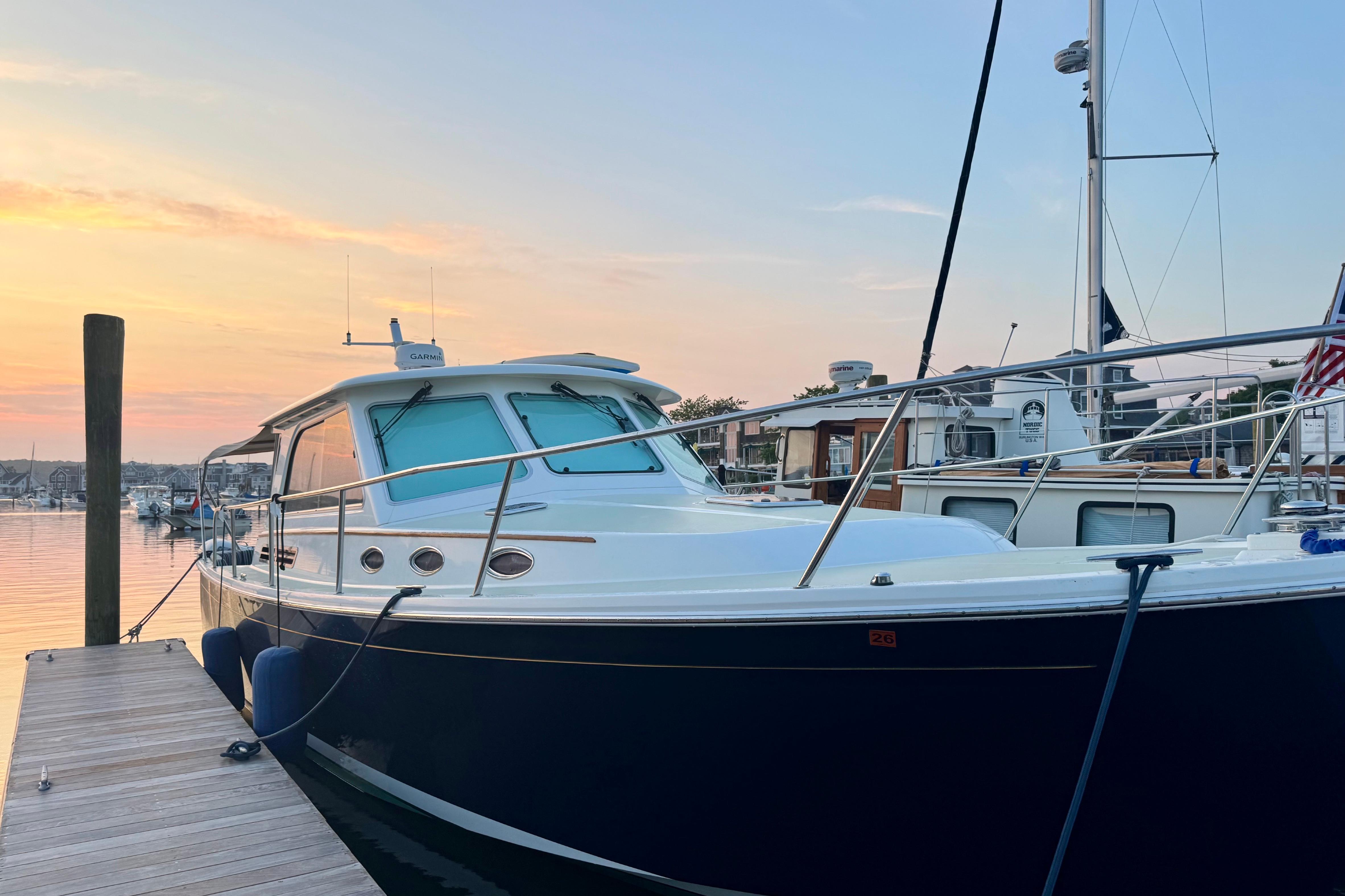 2019 Back Cove 37 yacht docked at sunset, showcasing sleek design and elegance.