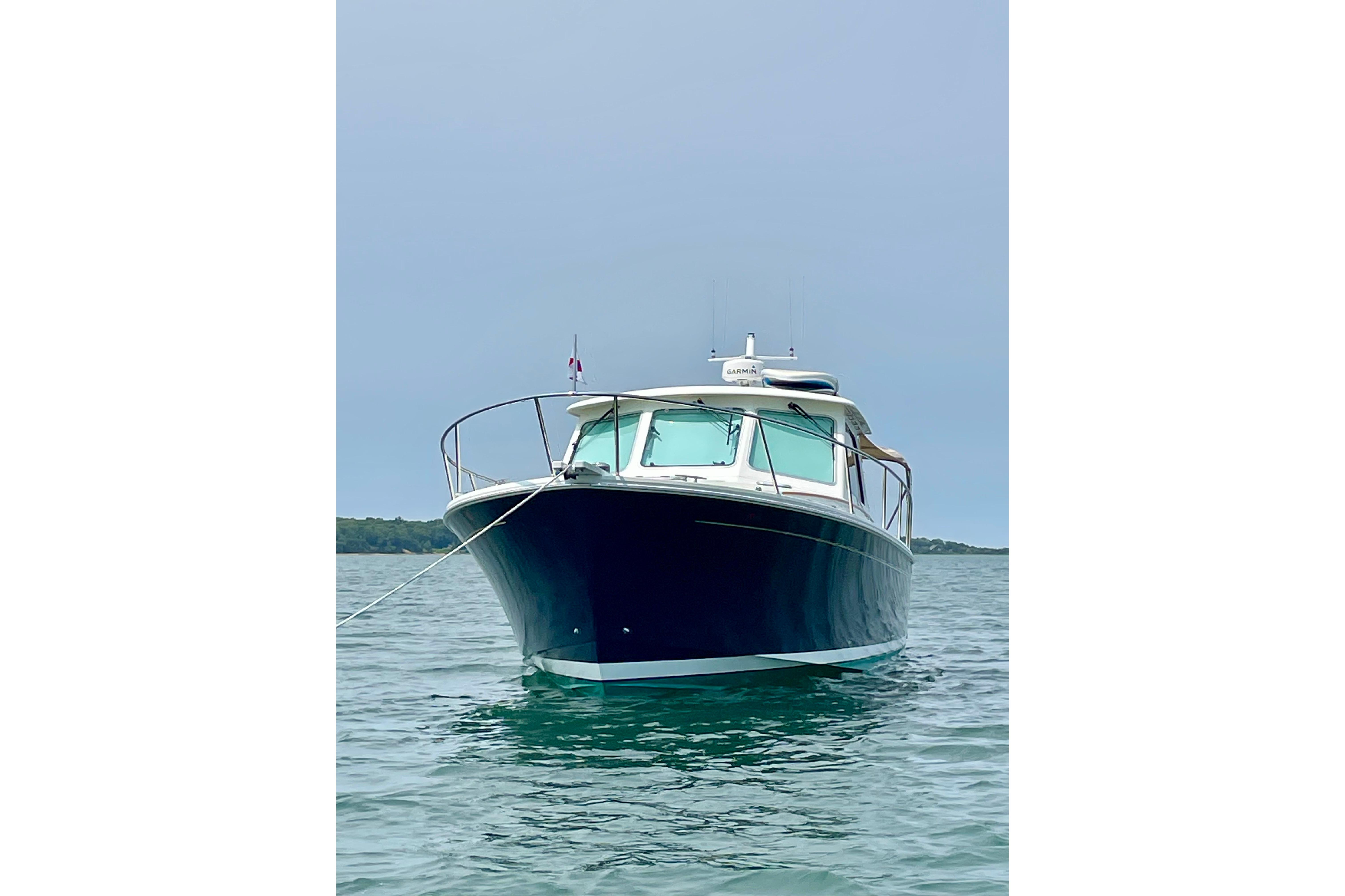 2019 Back Cove 37 boat anchored on calm water, front view.