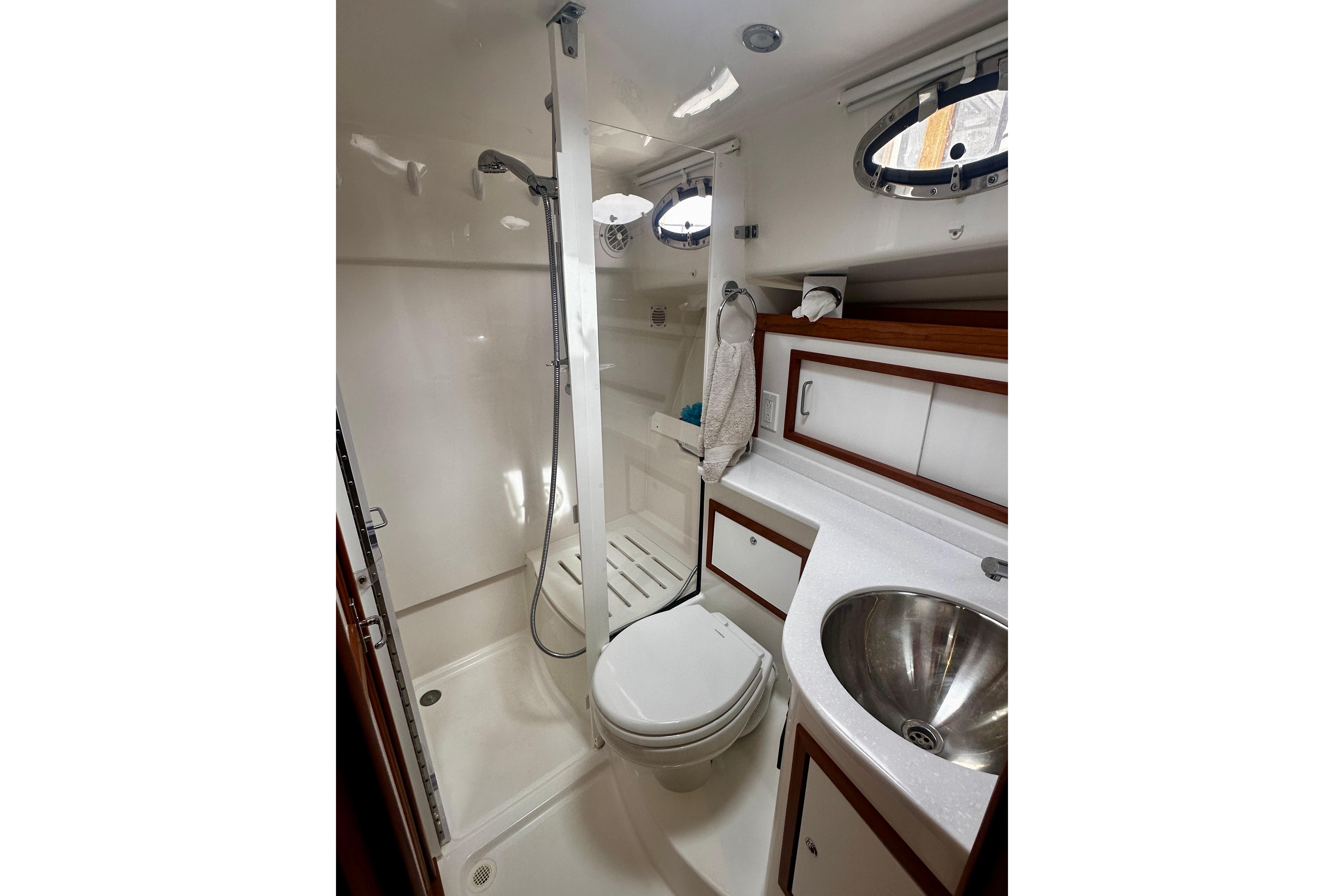 Luxurious bathroom in 2019 Back Cove 37 yacht with shower, sink, and toilet.
