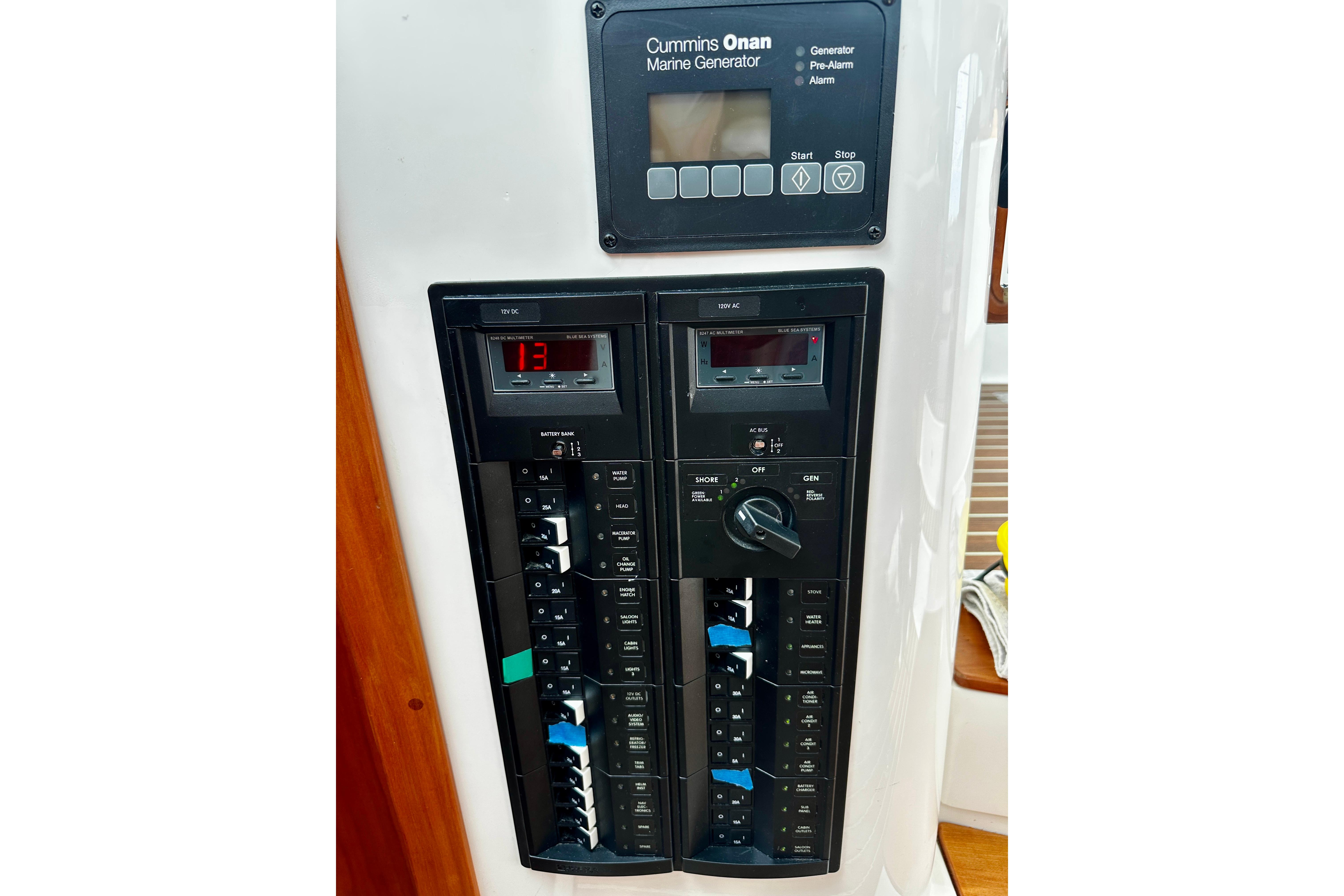 Electrical control panel on a 2019 Back Cove 37 boat, featuring Cummins Onan marine generator.