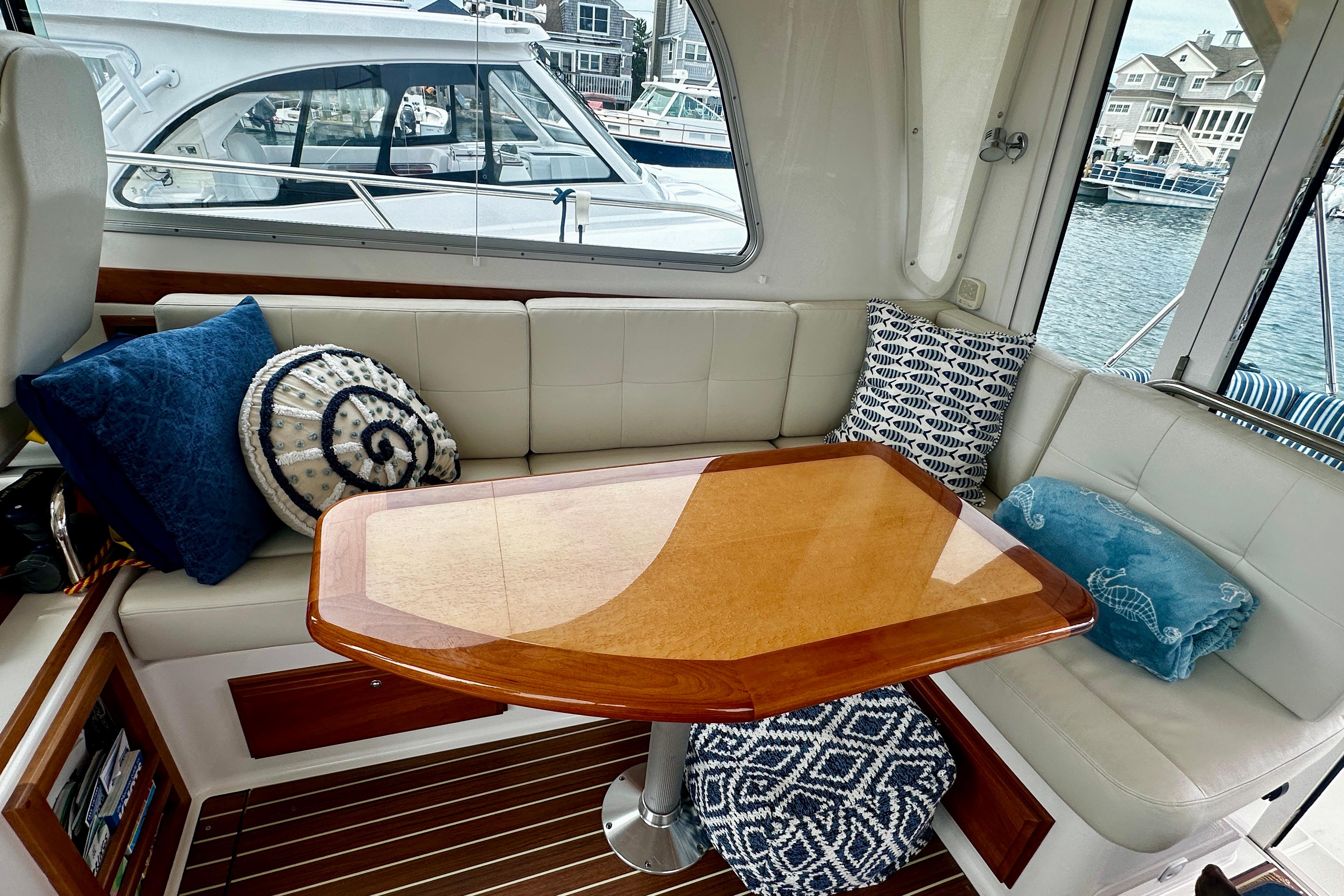 2019 Back Cove 37 yacht interior with elegant seating, wooden table, and decorative cushions.