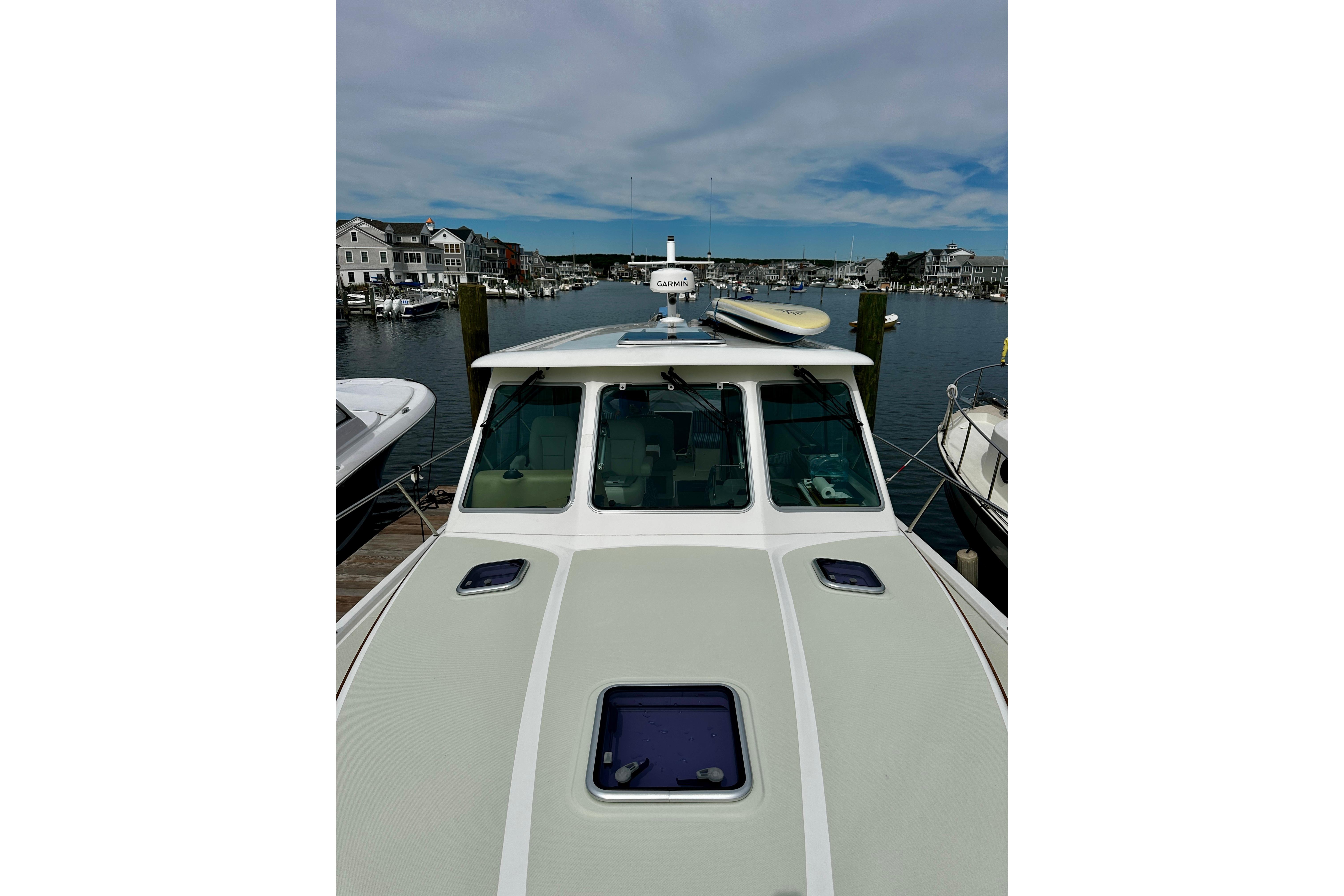 2019 Back Cove 37 yacht docked in a marina with scenic waterfront view.