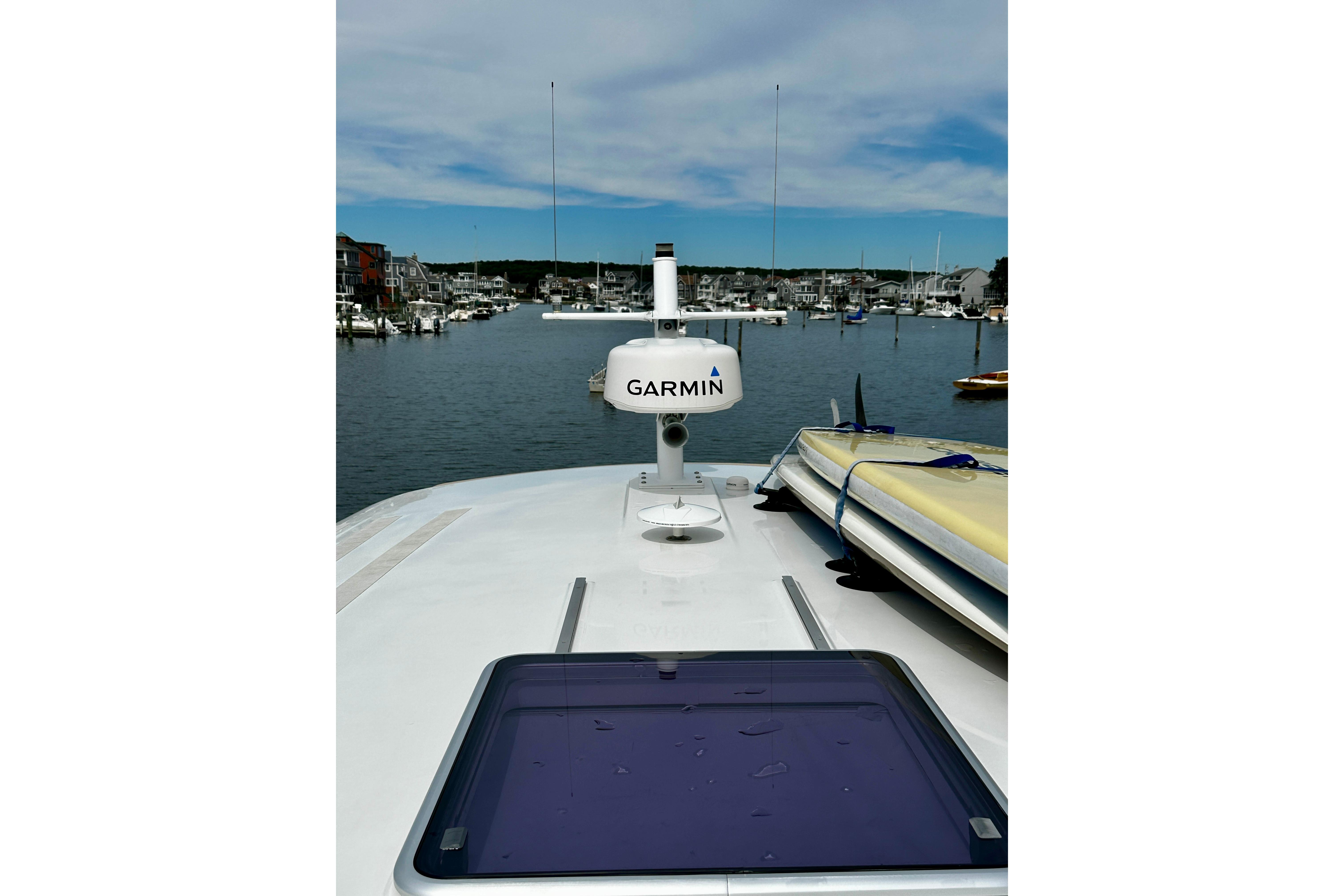 2019 Back Cove 37 yacht with Garmin equipment, docked in a scenic marina.