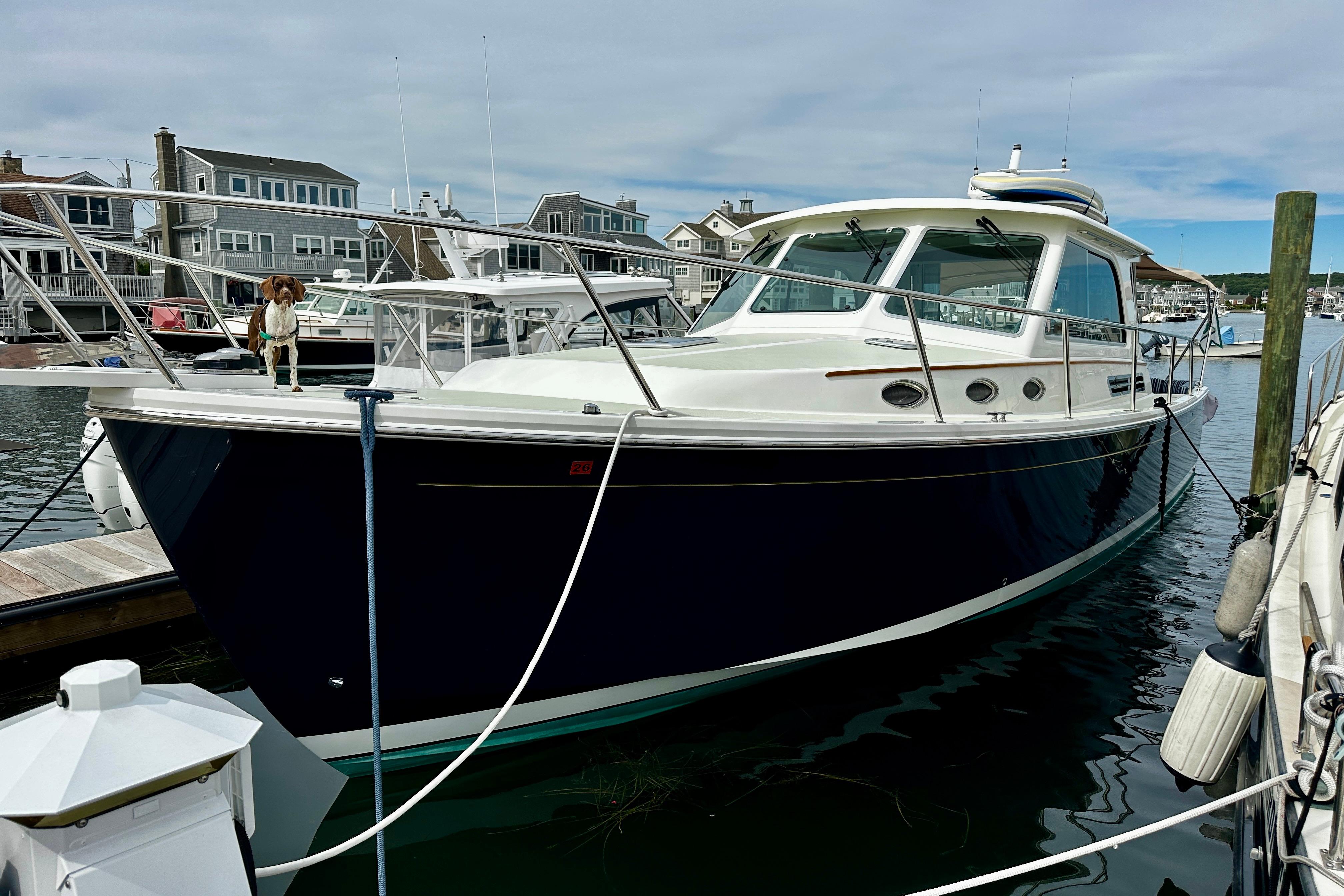 2019 Back Cove 37 yacht docked at marina with a dog on deck.