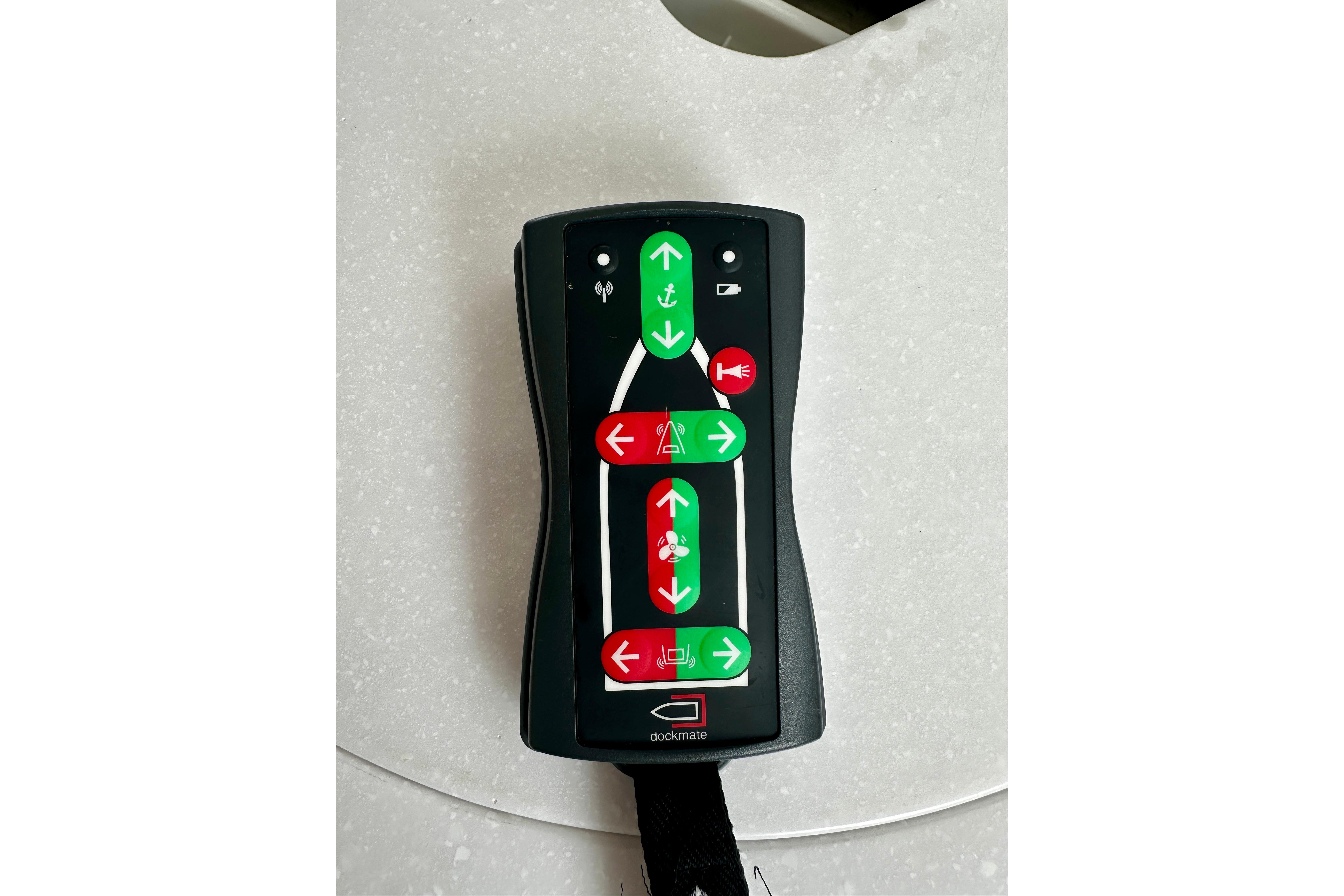 Remote control for 2019 Back Cove 37 boat, featuring directional buttons on a white surface.