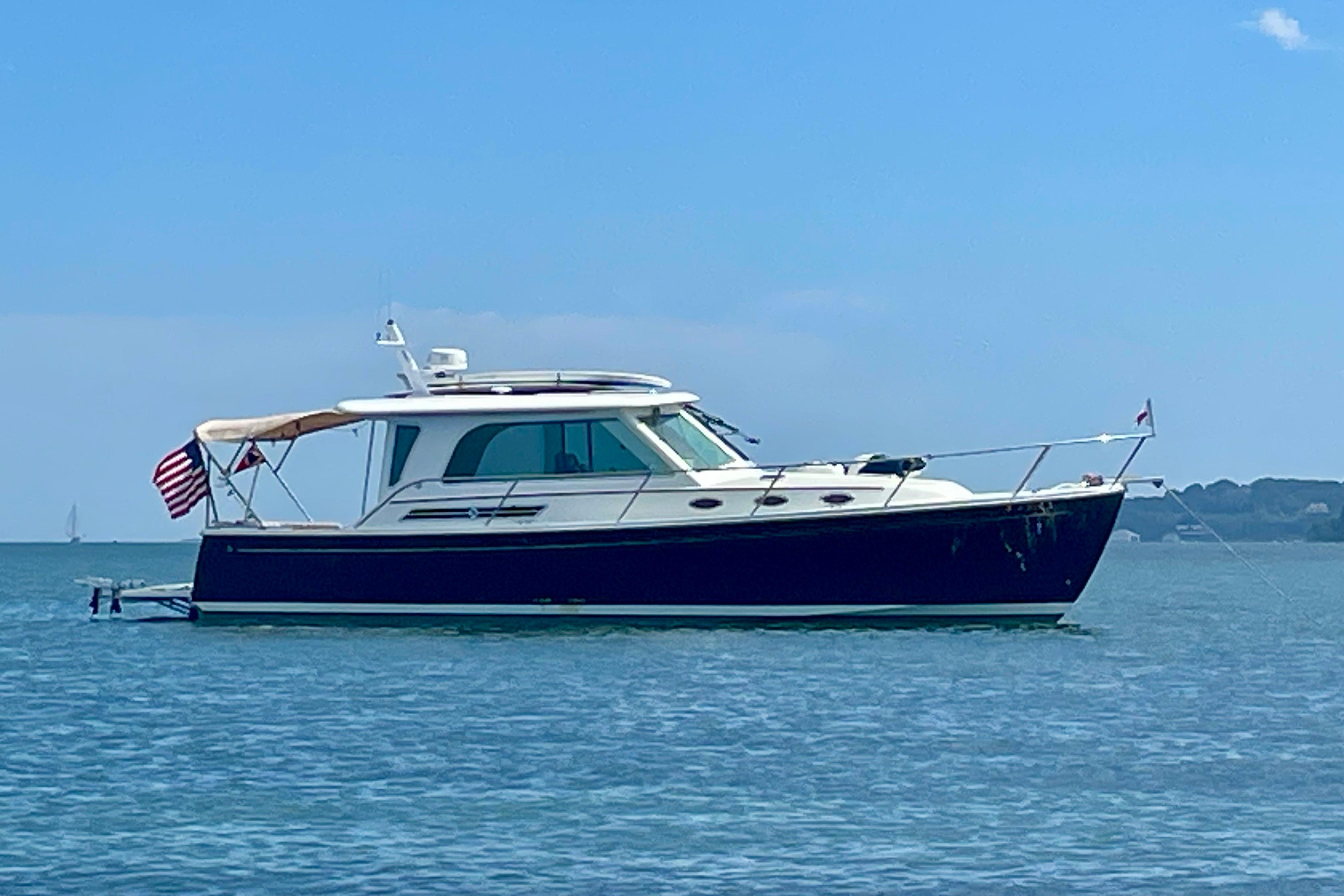 2019 Back Cove 37 yacht on calm water with clear blue sky.