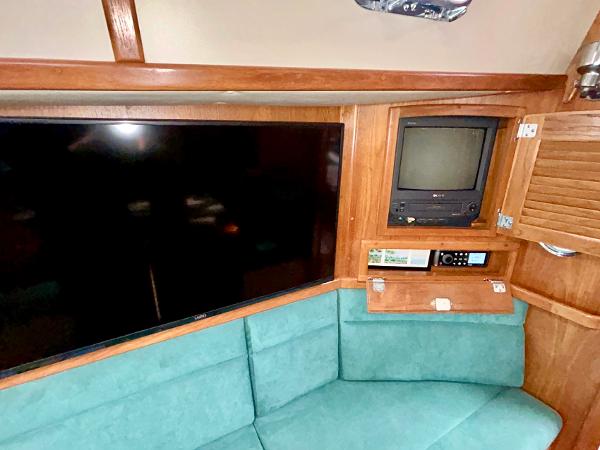 Interior of 1999 Pacific Seacraft 40 Voyagemaker with TV and green seating.