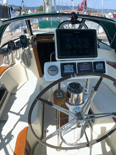 Cockpit of 1999 Pacific Seacraft 40 Voyagemaker sailboat with navigation instruments and steering wheel.