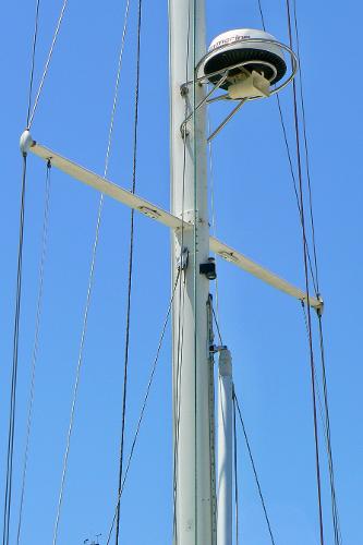 Mast of 1999 Pacific Seacraft 40 Voyagemaker sailboat against clear blue sky.
