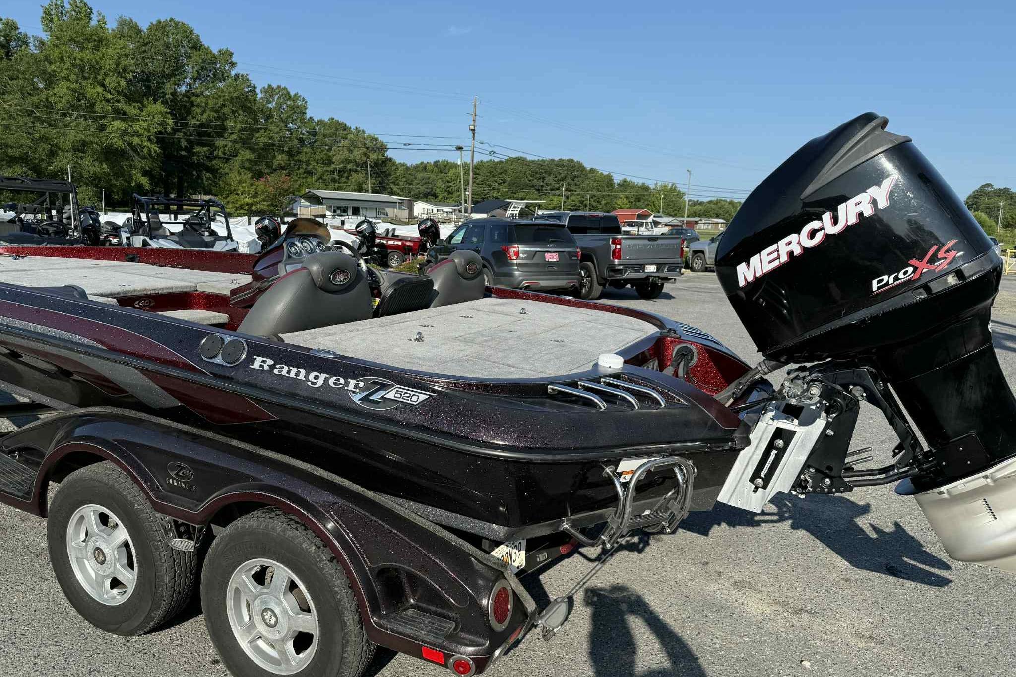 2008 Ranger Z520 Comanche boat with Mercury Pro XS engine in parking lot.