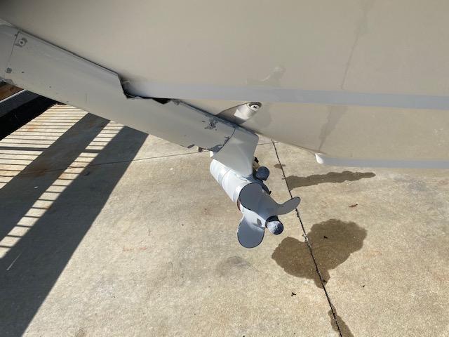 Propeller of 2005 Boston Whaler 275 Conquest boat on concrete surface.