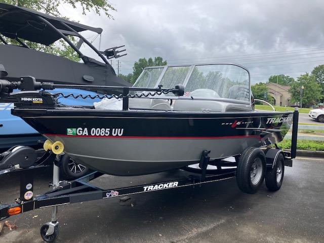 2014 Tracker Pro Guide V-16 WT fishing boat on trailer, parked outdoors.