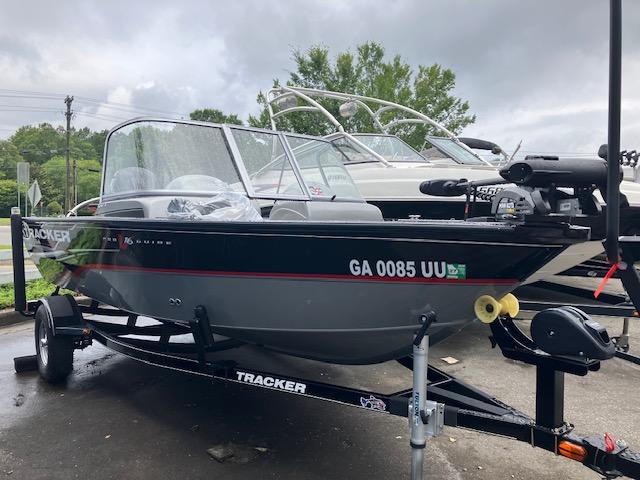 2014 Tracker Pro Guide V-16 WT boat on trailer, parked outdoors.
