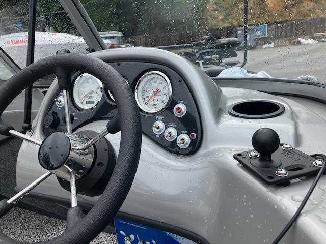 2014 Tracker Pro Guide V-16 WT boat dashboard with steering wheel and gauges.