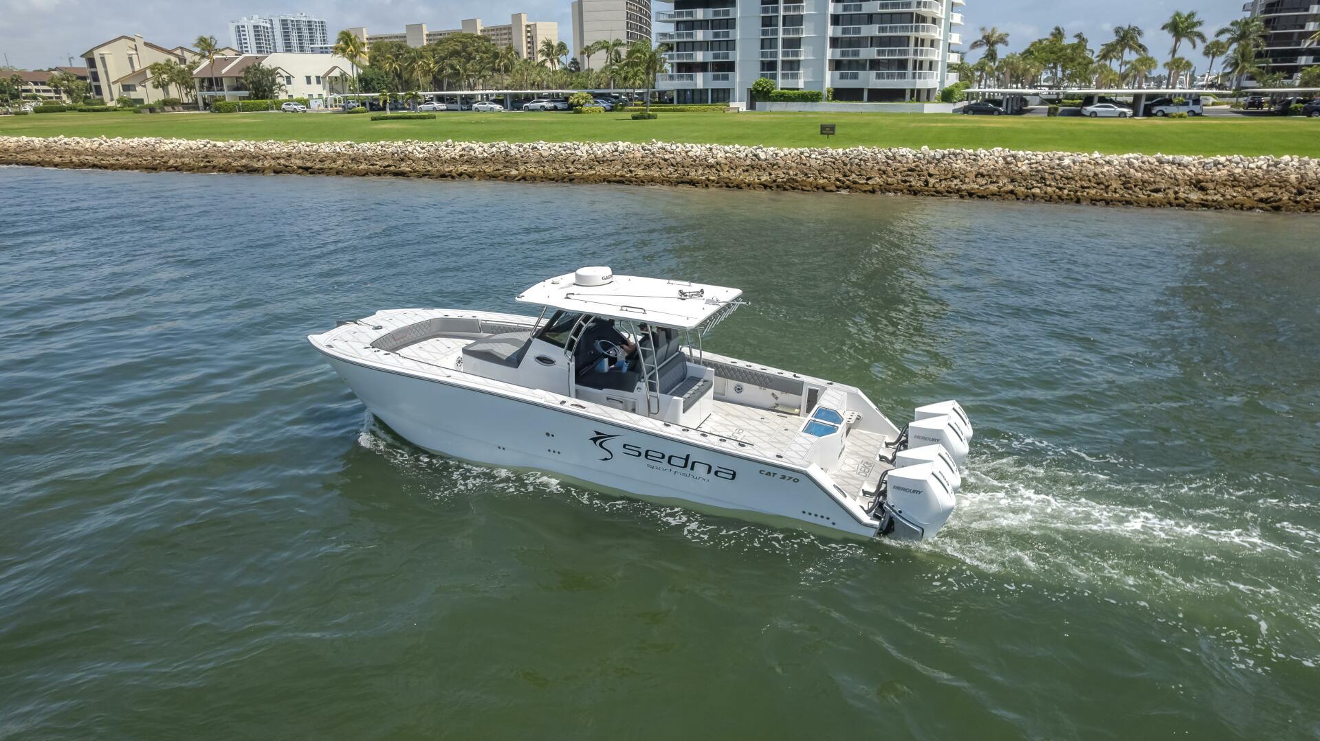 Sedna-37 Open 2025 -FL-US-2025 Sedna 37 Open boat cruising on water near a coastal cityscape.-9788651