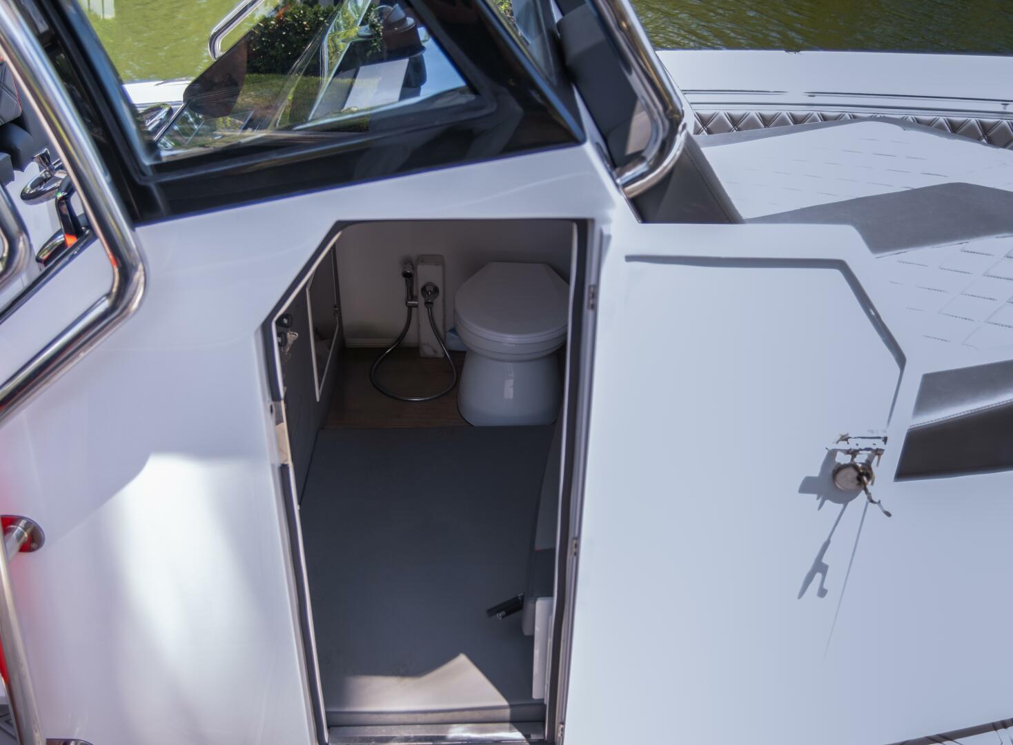 Sedna-37 Open 2025 -FL-US-Sedna 37 Open 2025 boat with open cabin door revealing interior toilet.-9788651 | Thumbnail