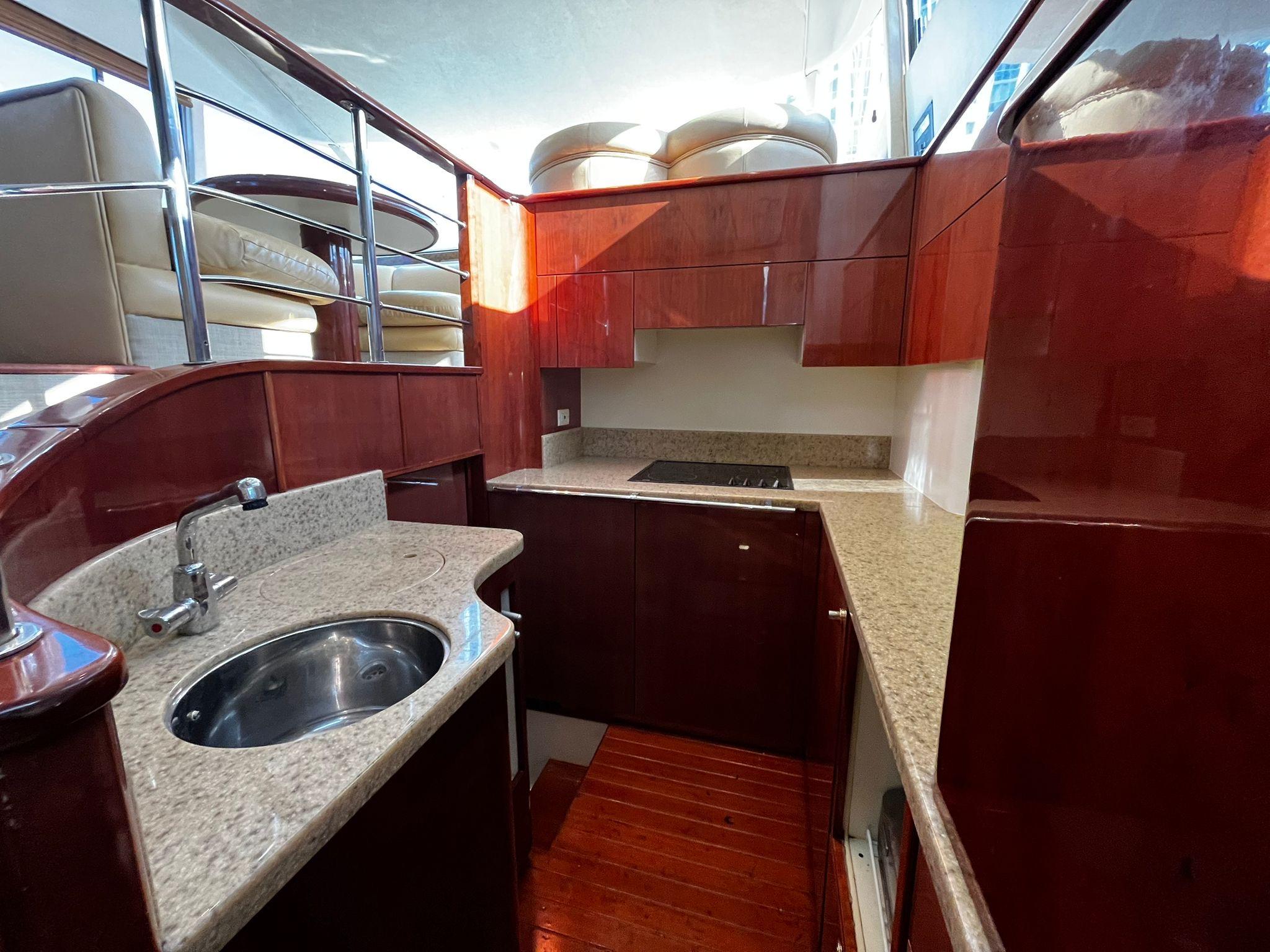Fairline-Squadron 55 2001 -FL-US-Luxurious kitchen interior of 2001 Fairline Squadron 55 yacht with wood and granite finishes.-9778674 | Thumbnail