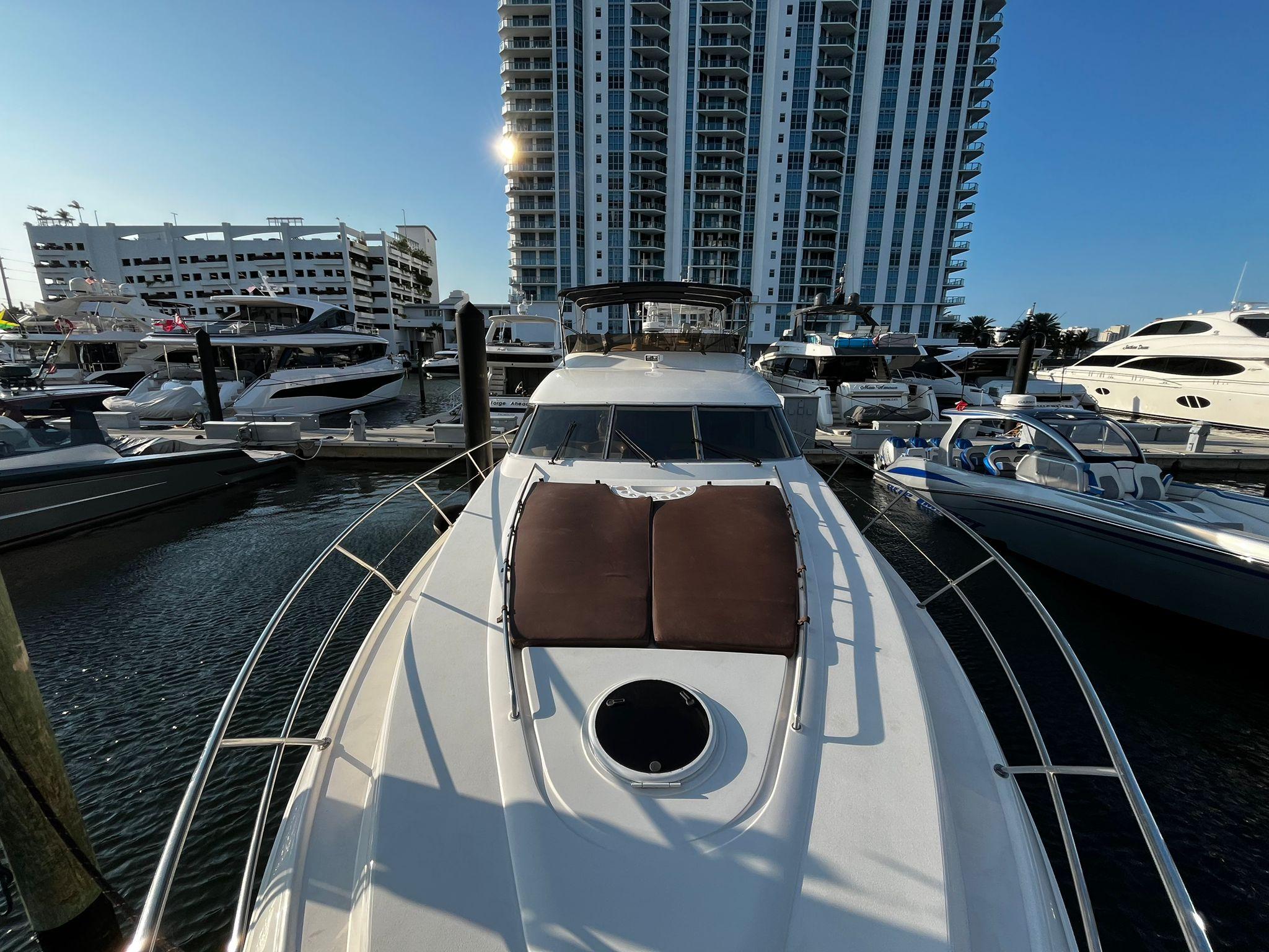 Fairline-Squadron 55 2001 -FL-US-2001 Fairline Squadron 55 yacht docked at marina, with modern high-rise buildings in background.-9778674 | Thumbnail