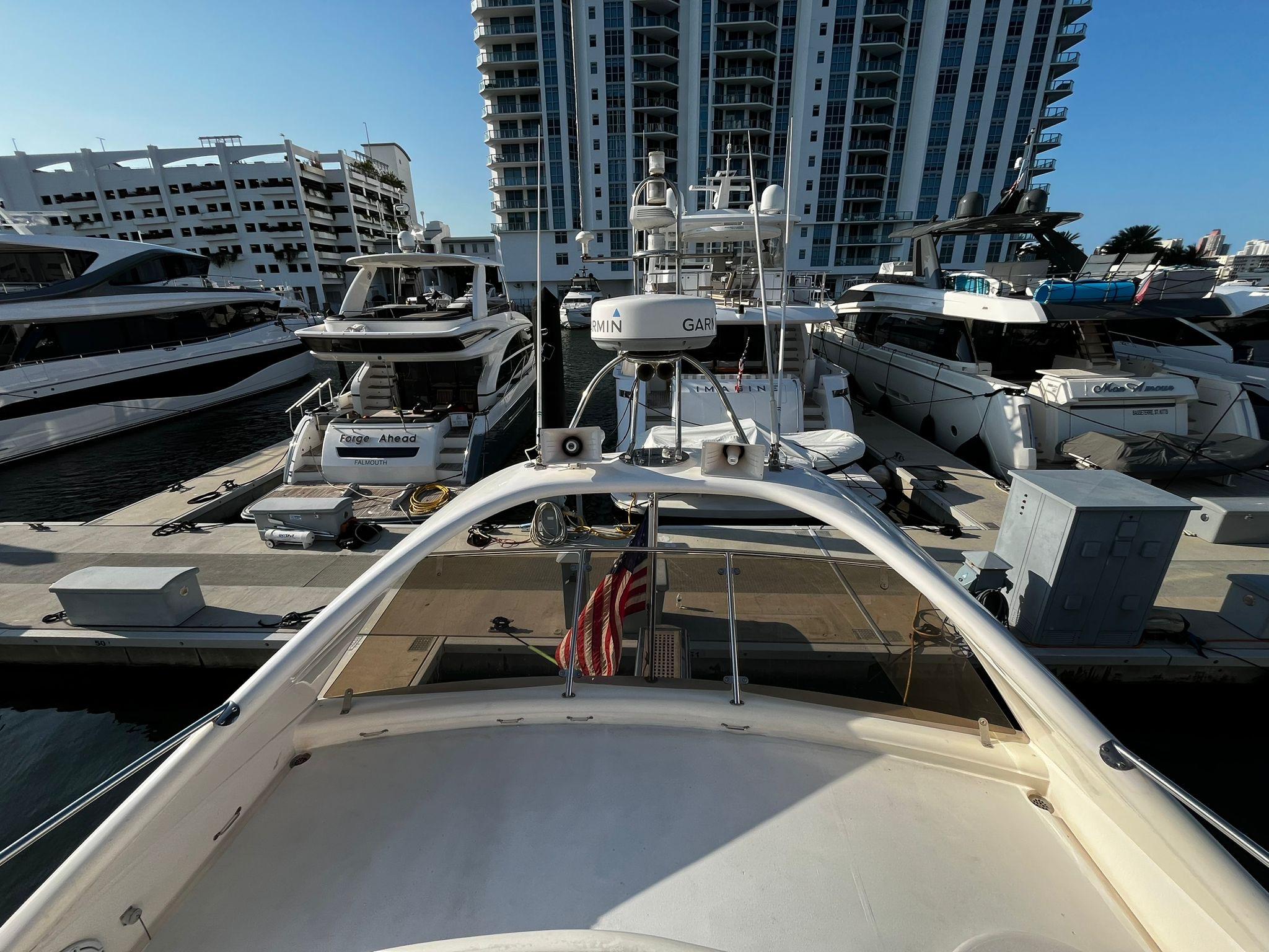 Fairline-Squadron 55 2001 -FL-US-2001 Fairline Squadron 55 yacht docked at a marina with modern buildings in the background.-9778674 | Thumbnail