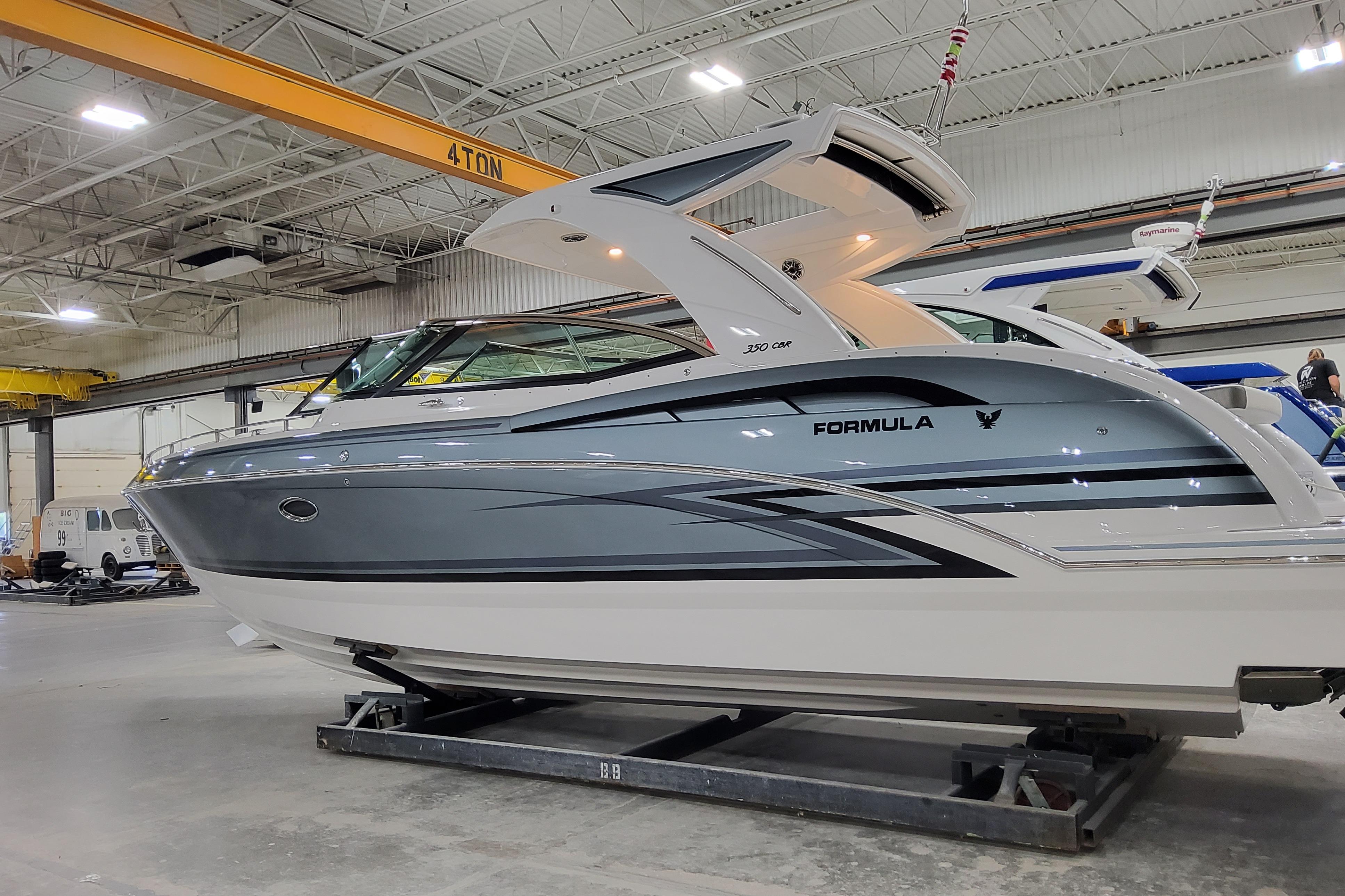 2025 Formula 350 Crossover Bowrider I/O in a showroom, showcasing sleek design and modern features.