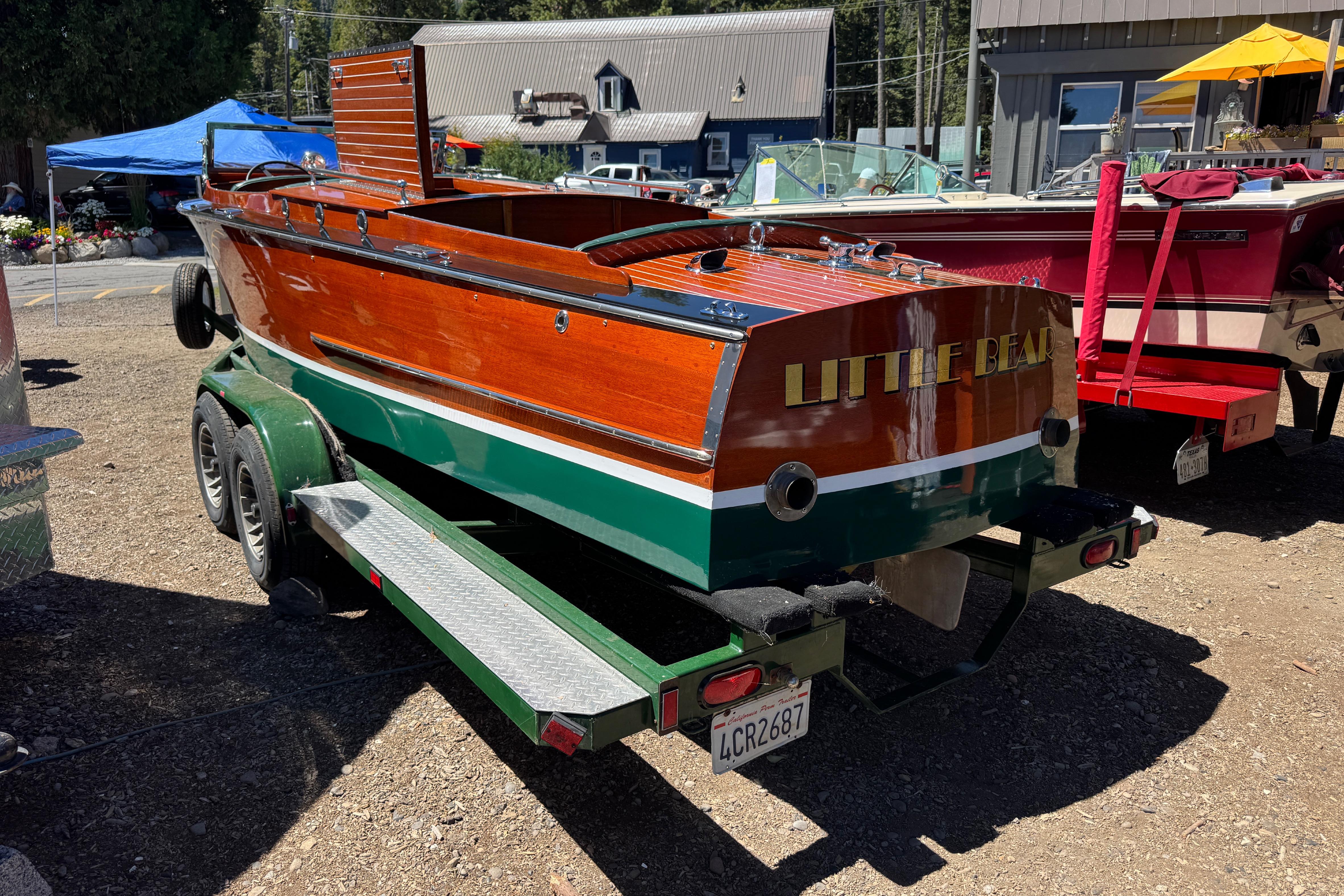 1987 Grand Craft Triple Cockpit Runabout boat named "Little Bear" on a trailer.