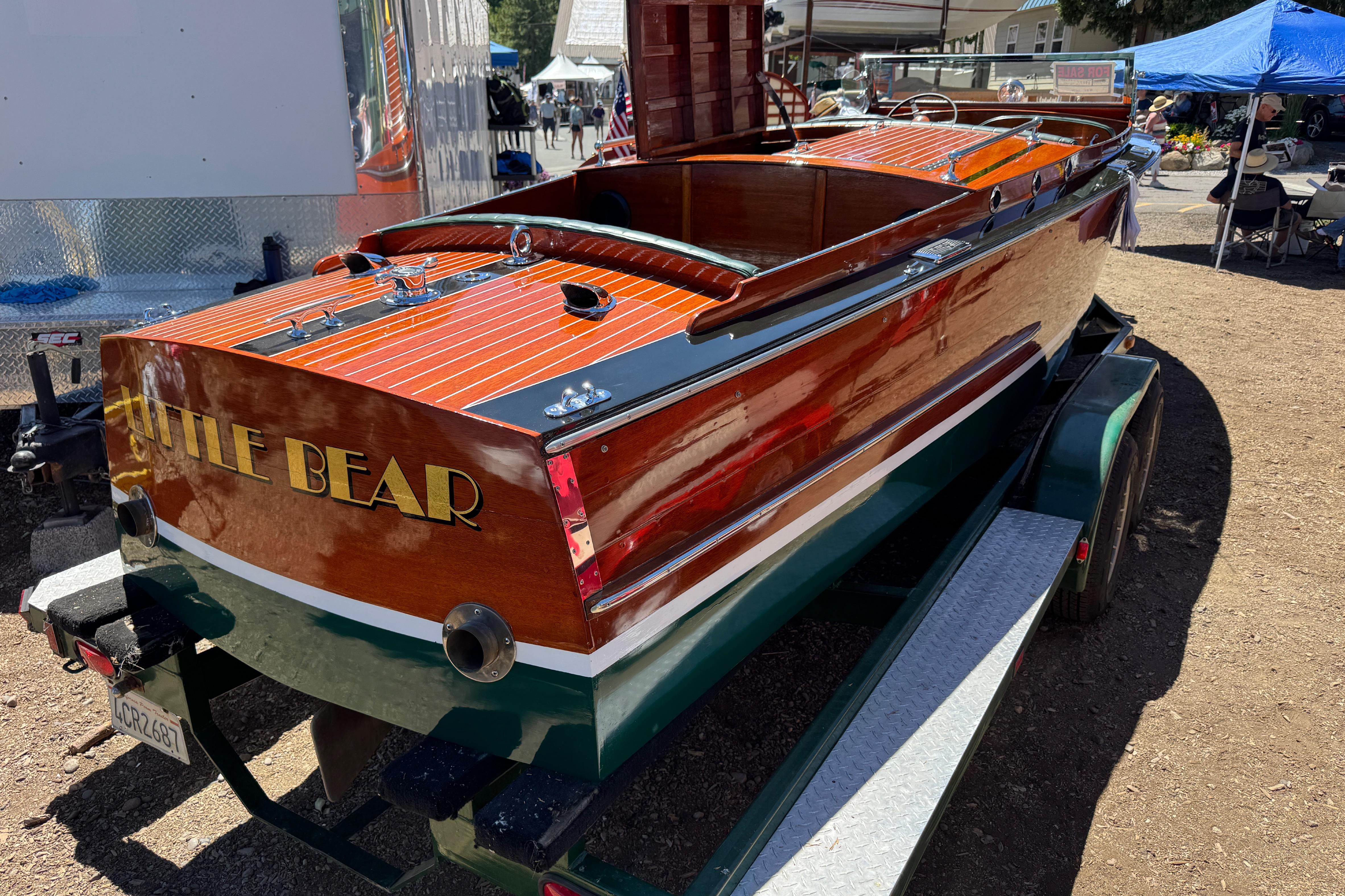 1987 Grand Craft Triple Cockpit Runabout "Little Bear" on trailer at outdoor event.