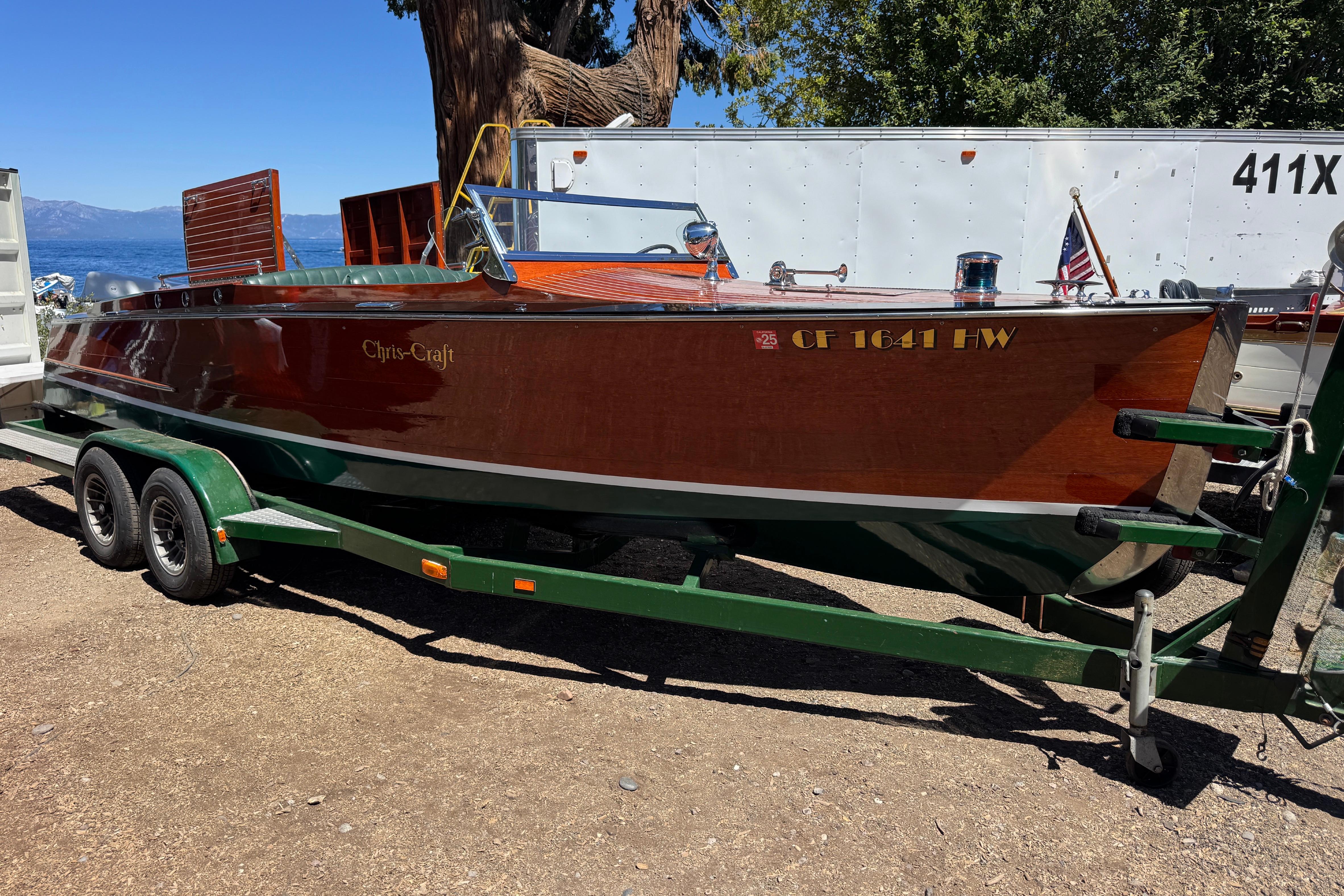 1987 Grand Craft Triple Cockpit Runabout on trailer, classic wooden boat design.
