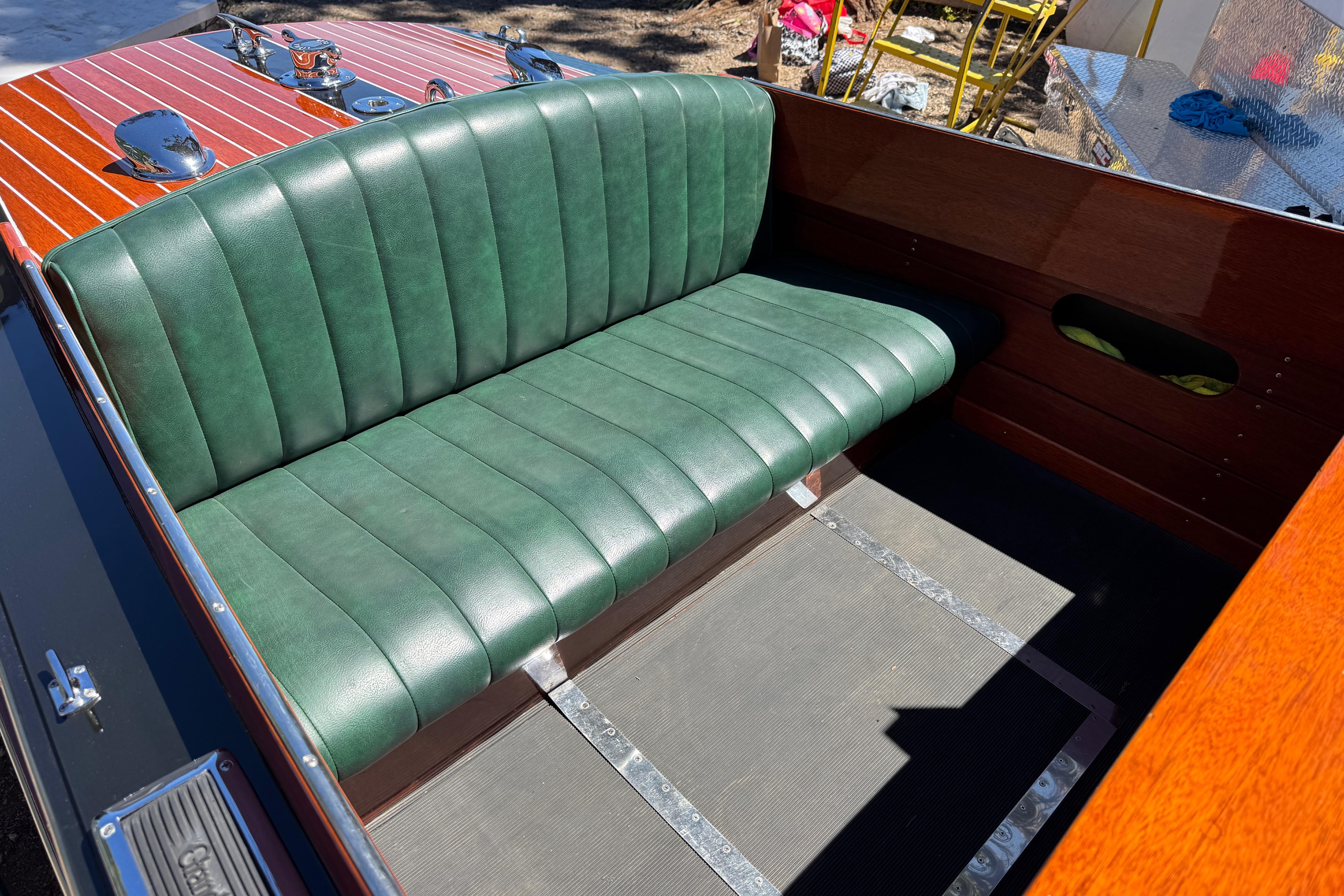 1987 Grand Craft Triple Cockpit Runabout with green leather seating and polished wood finish.