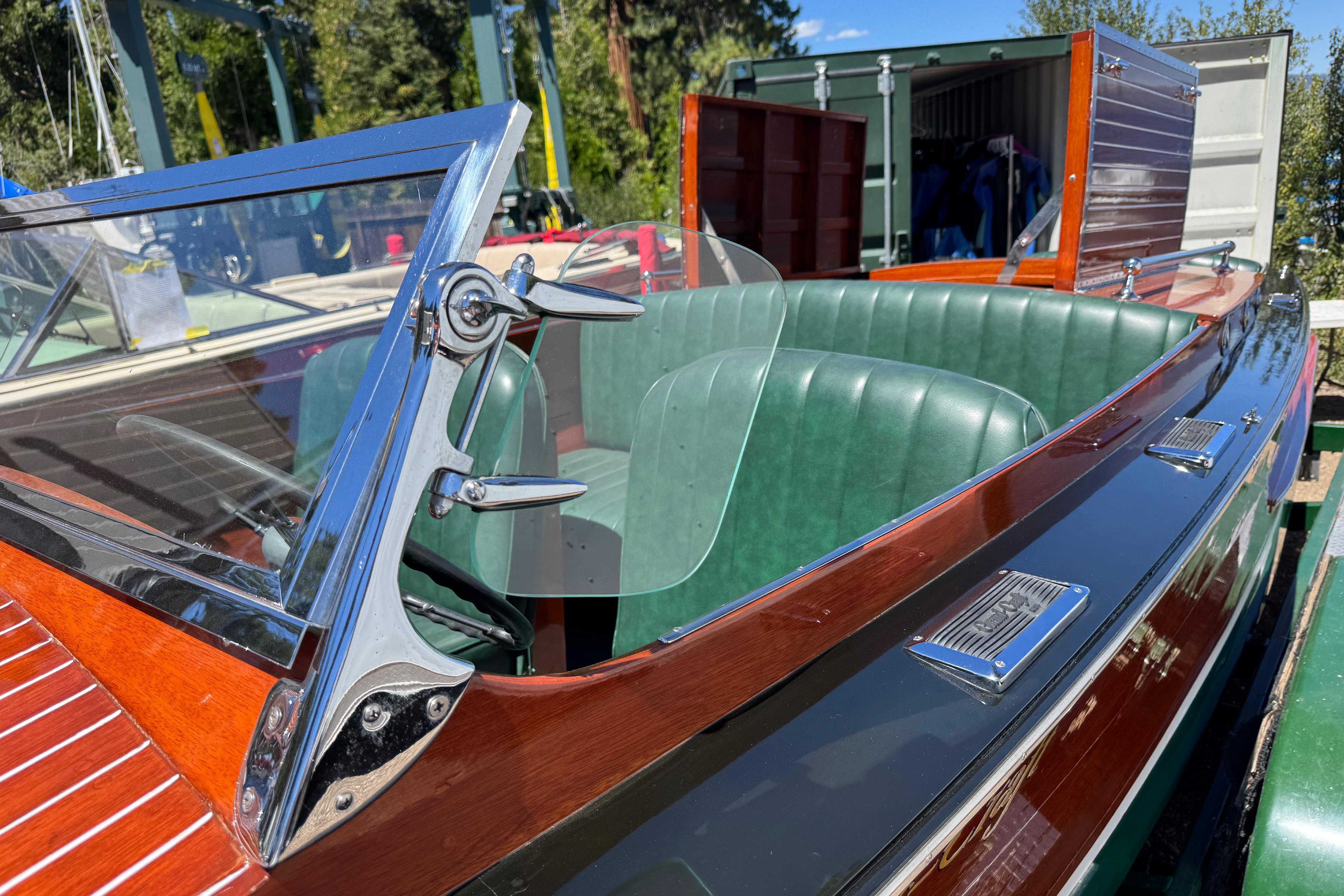 1987 Grand Craft Triple Cockpit Runabout with green leather seats and polished wood finish.