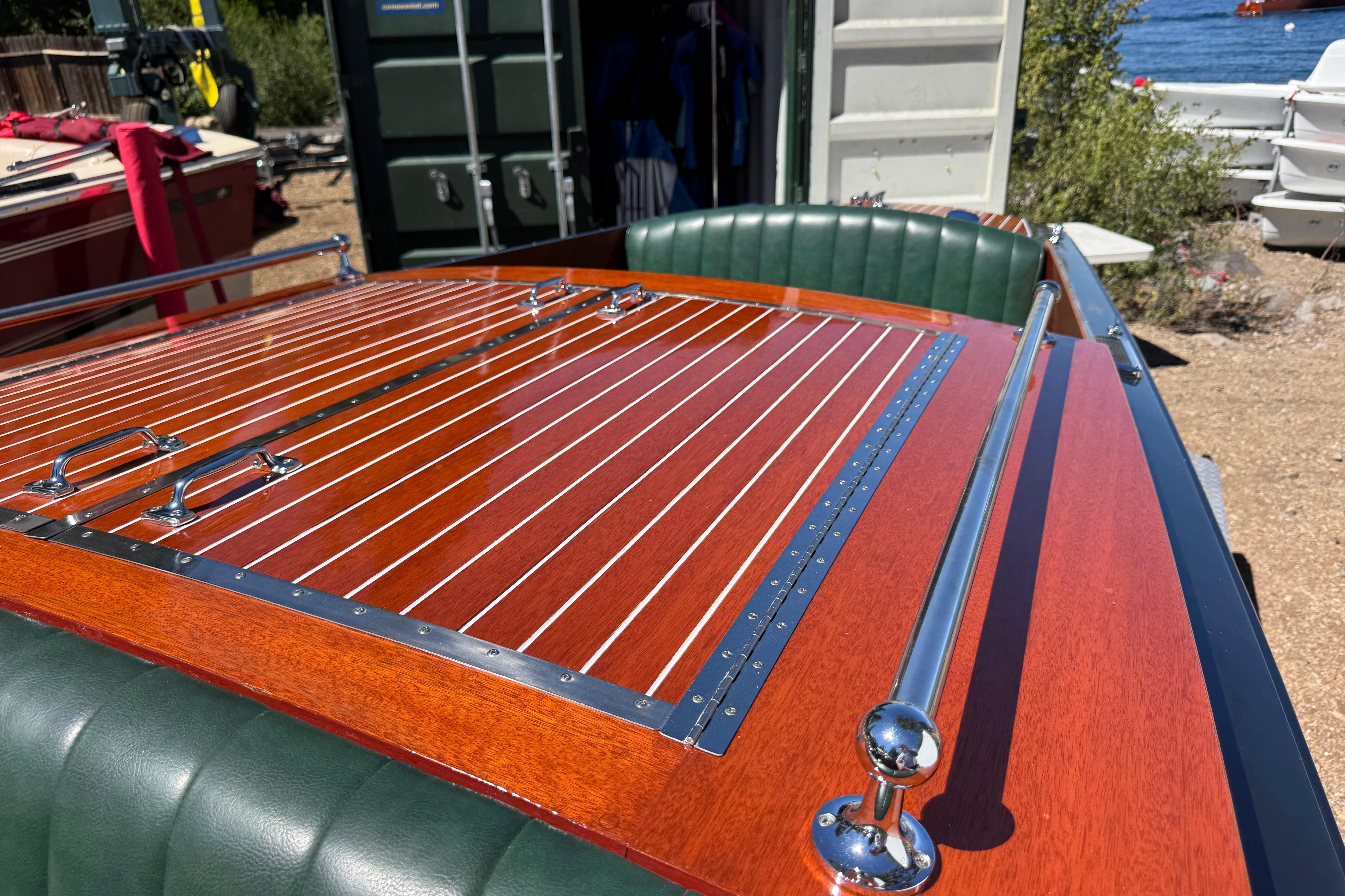 1987 Grand Craft Triple Cockpit Runabout with polished wood finish and green leather seats.