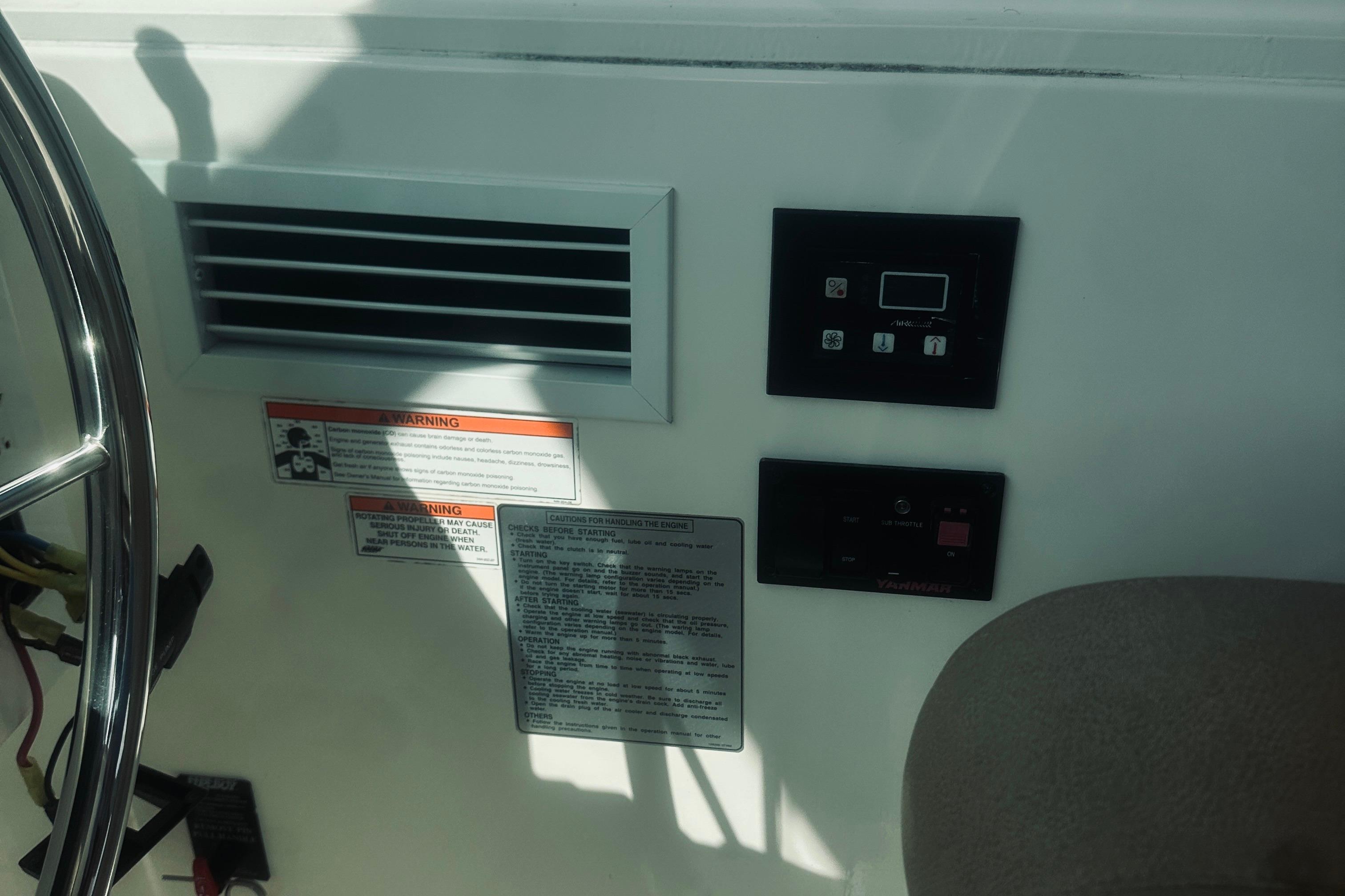 Control panel and warning labels on a 2013 Back Cove 30 boat dashboard.