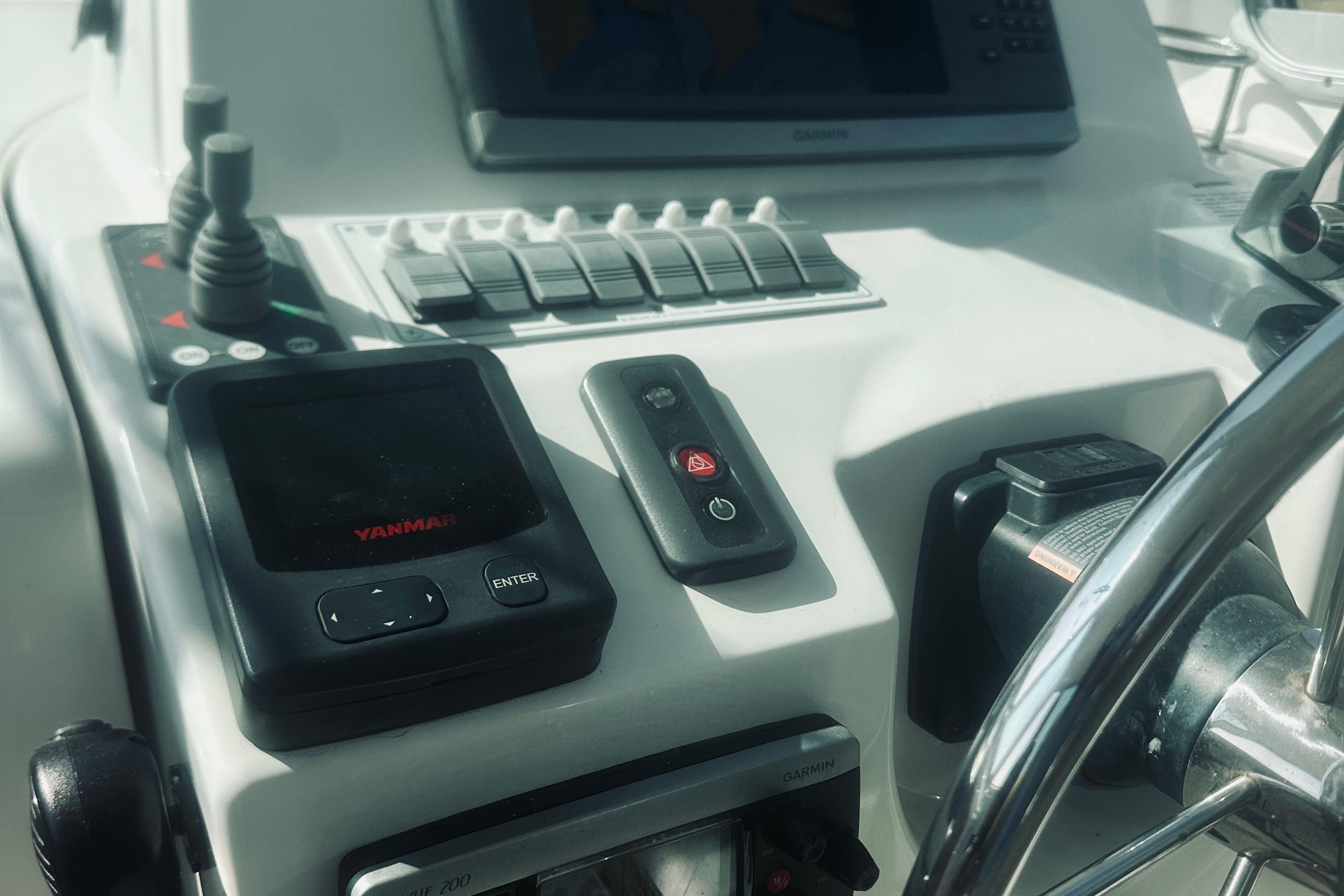 Control panel of a 2013 Back Cove 30 boat with Yanmar and Garmin displays.