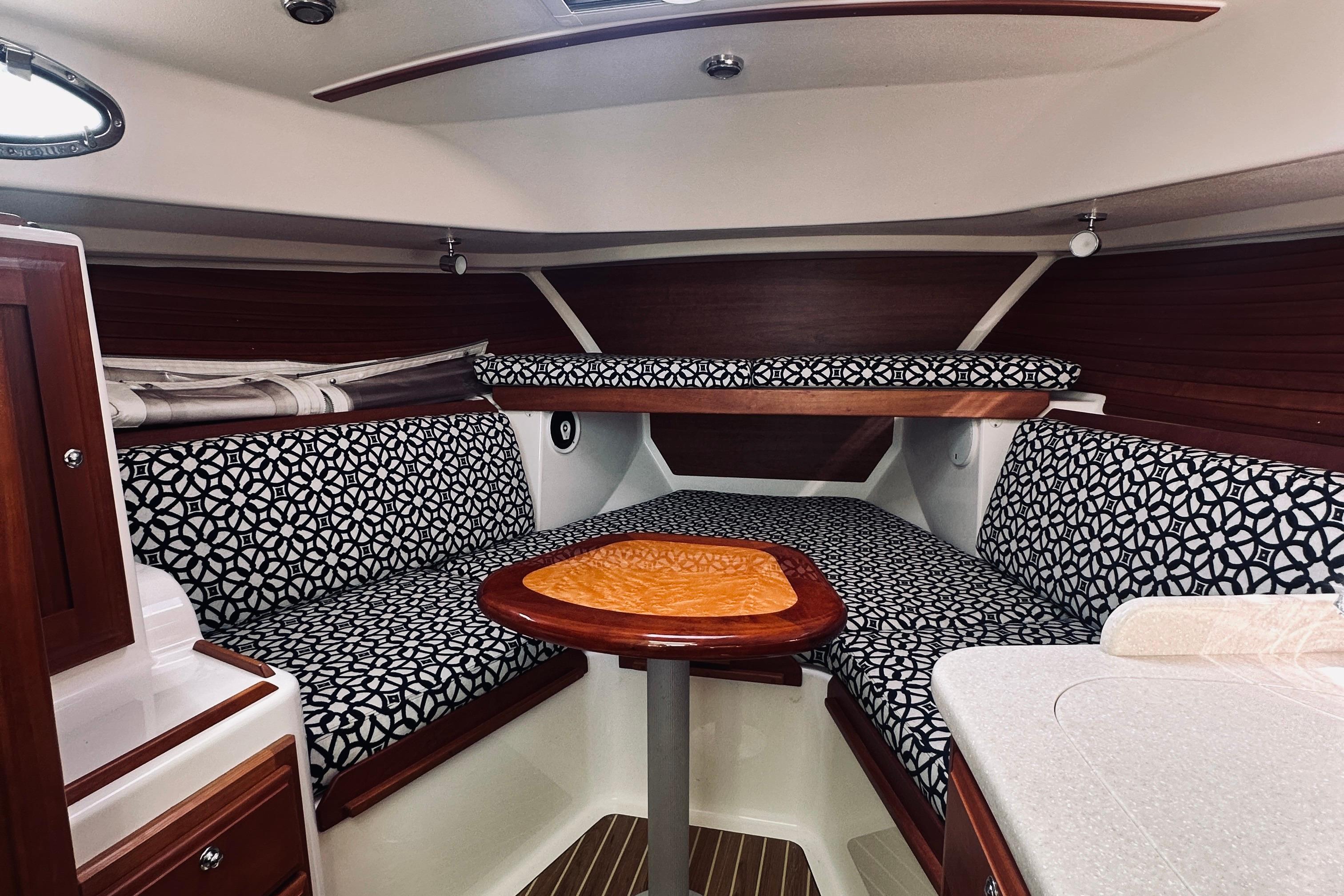 2013 Back Cove 30 interior with patterned seating and wooden accents.