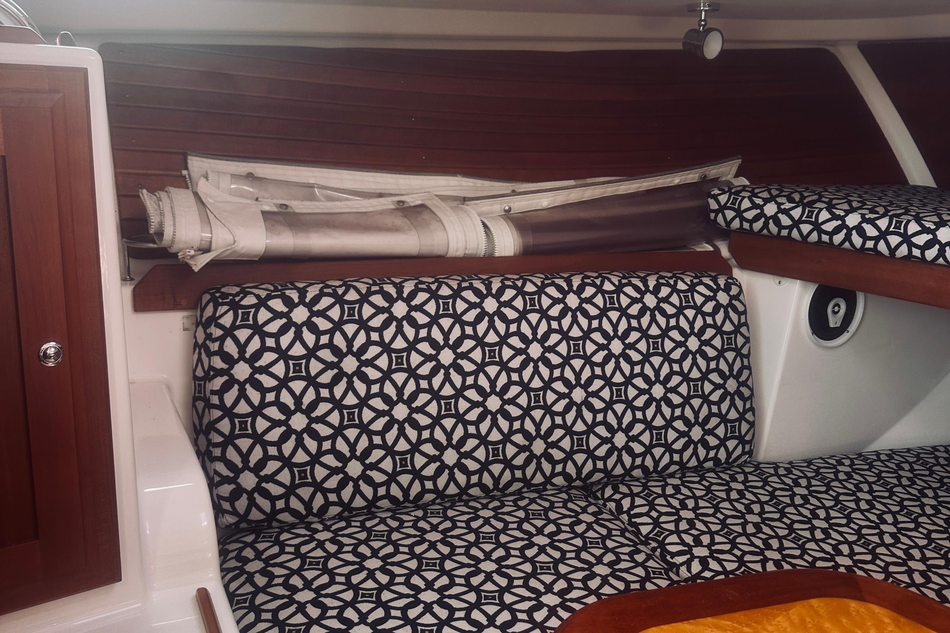 Interior of 2013 Back Cove 30 boat with patterned seating and wooden accents.