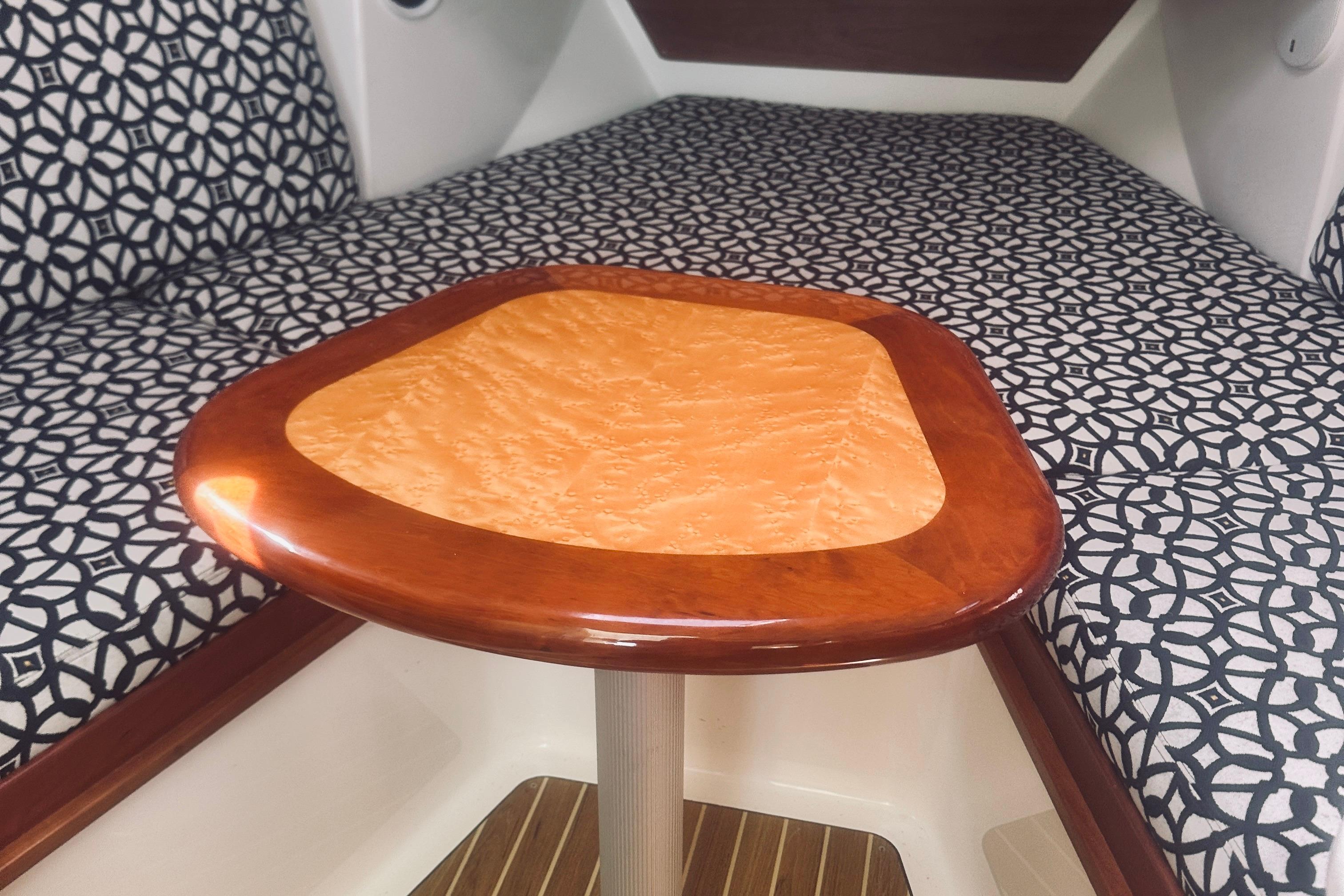 2013 Back Cove 30 interior with patterned cushions and polished wooden table.