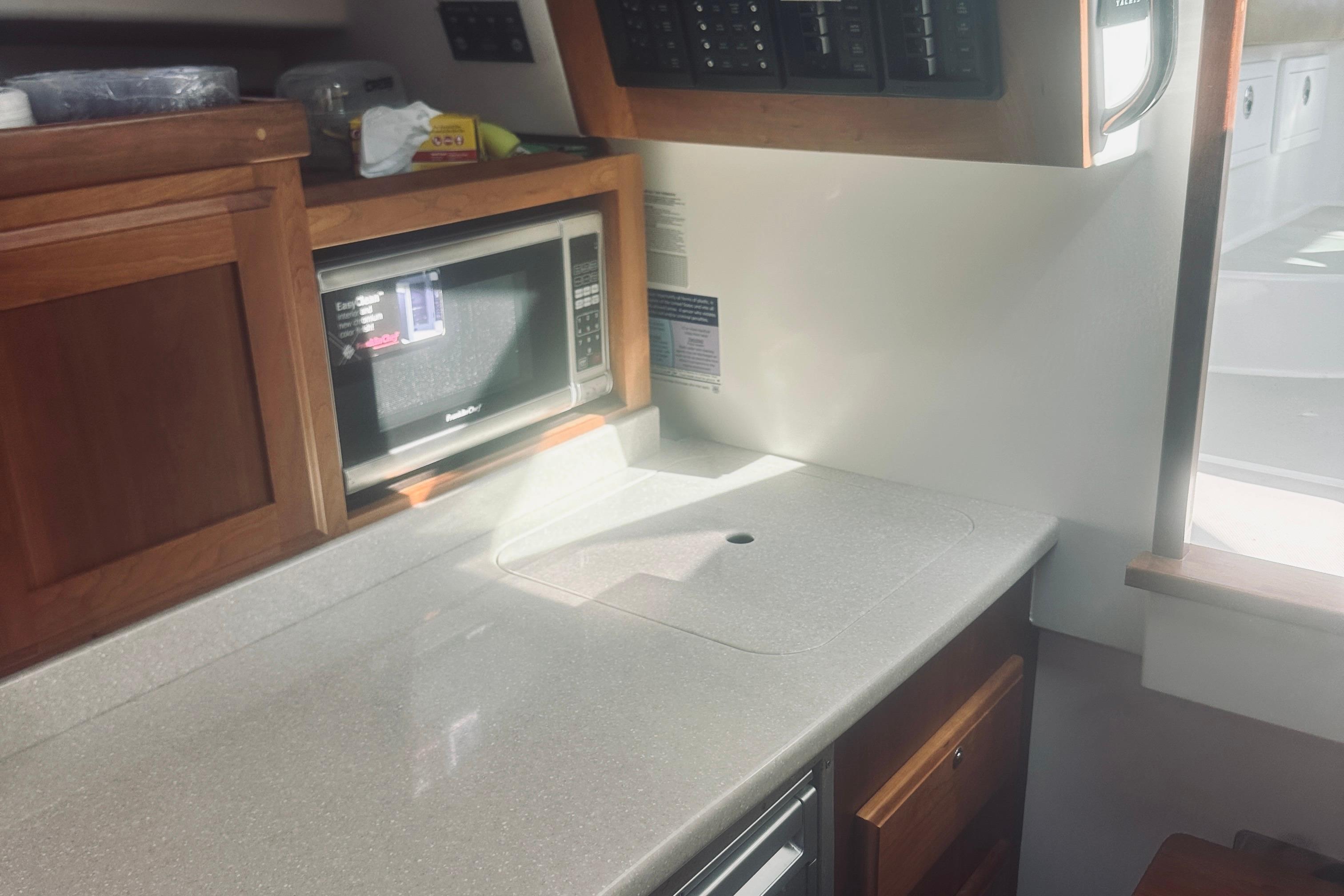 2013 Back Cove 30 yacht interior with microwave and wooden cabinetry.