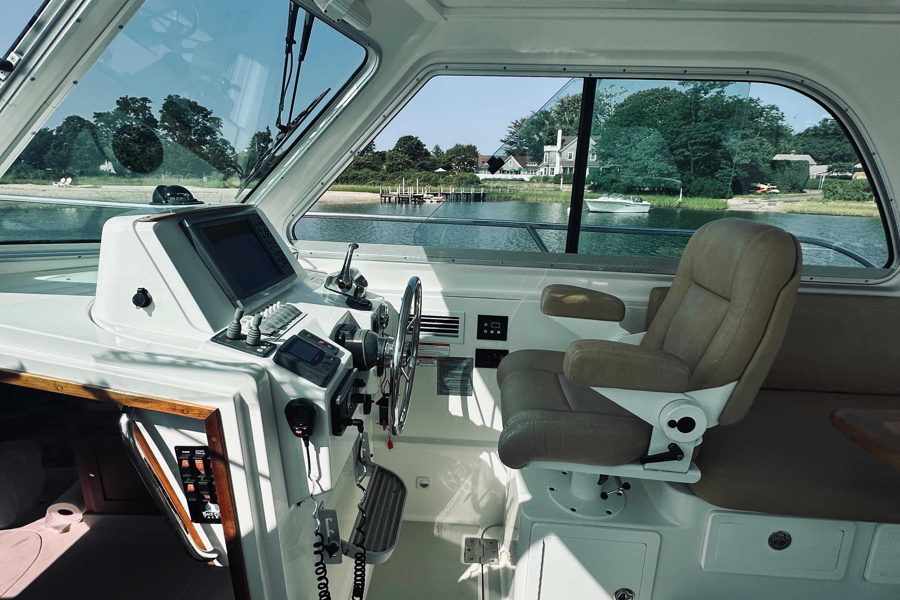 Interior of a 2013 Back Cove 30 boat with helm and captainu0027s chair.