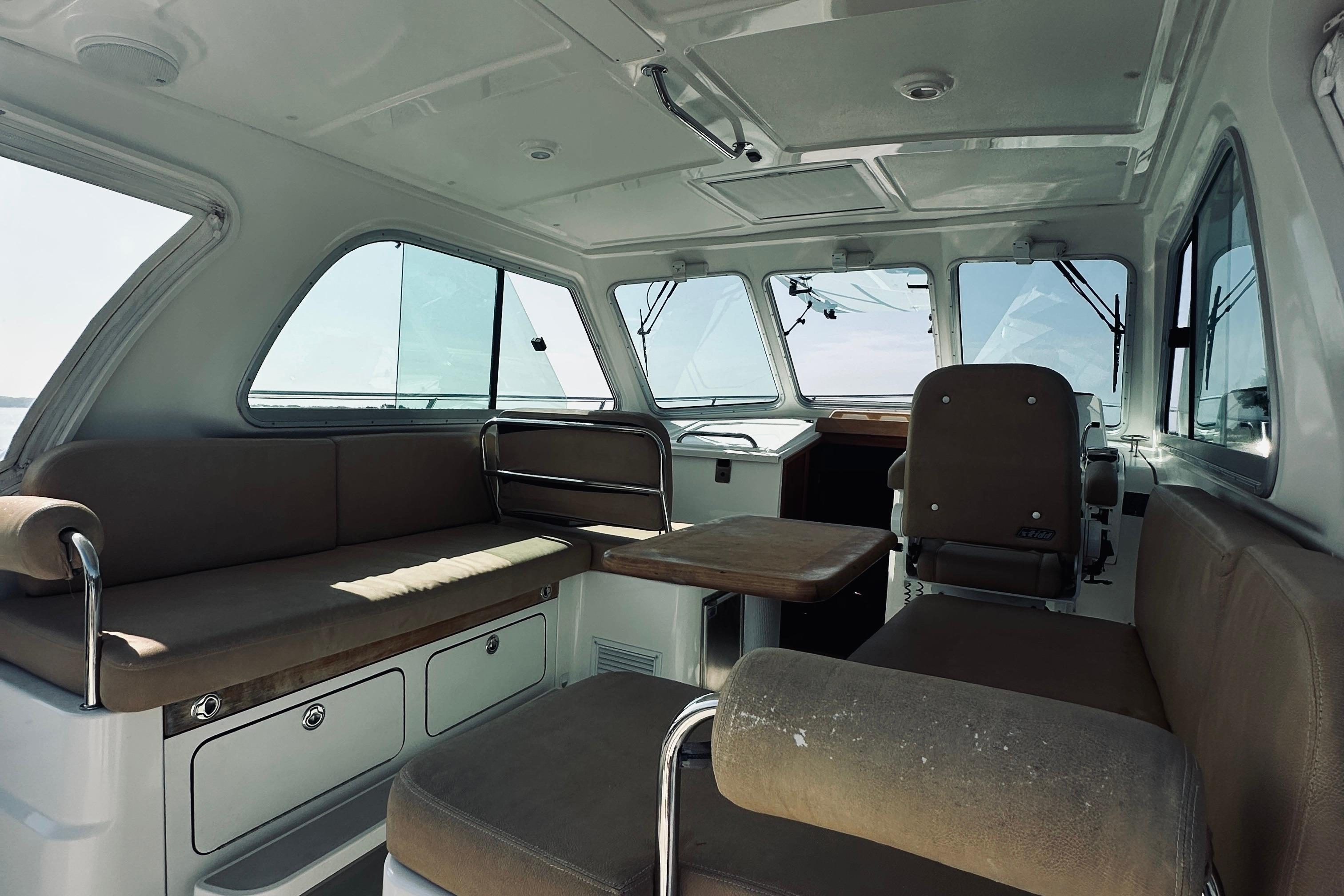 Interior of 2013 Back Cove 30 boat with seating and helm station.