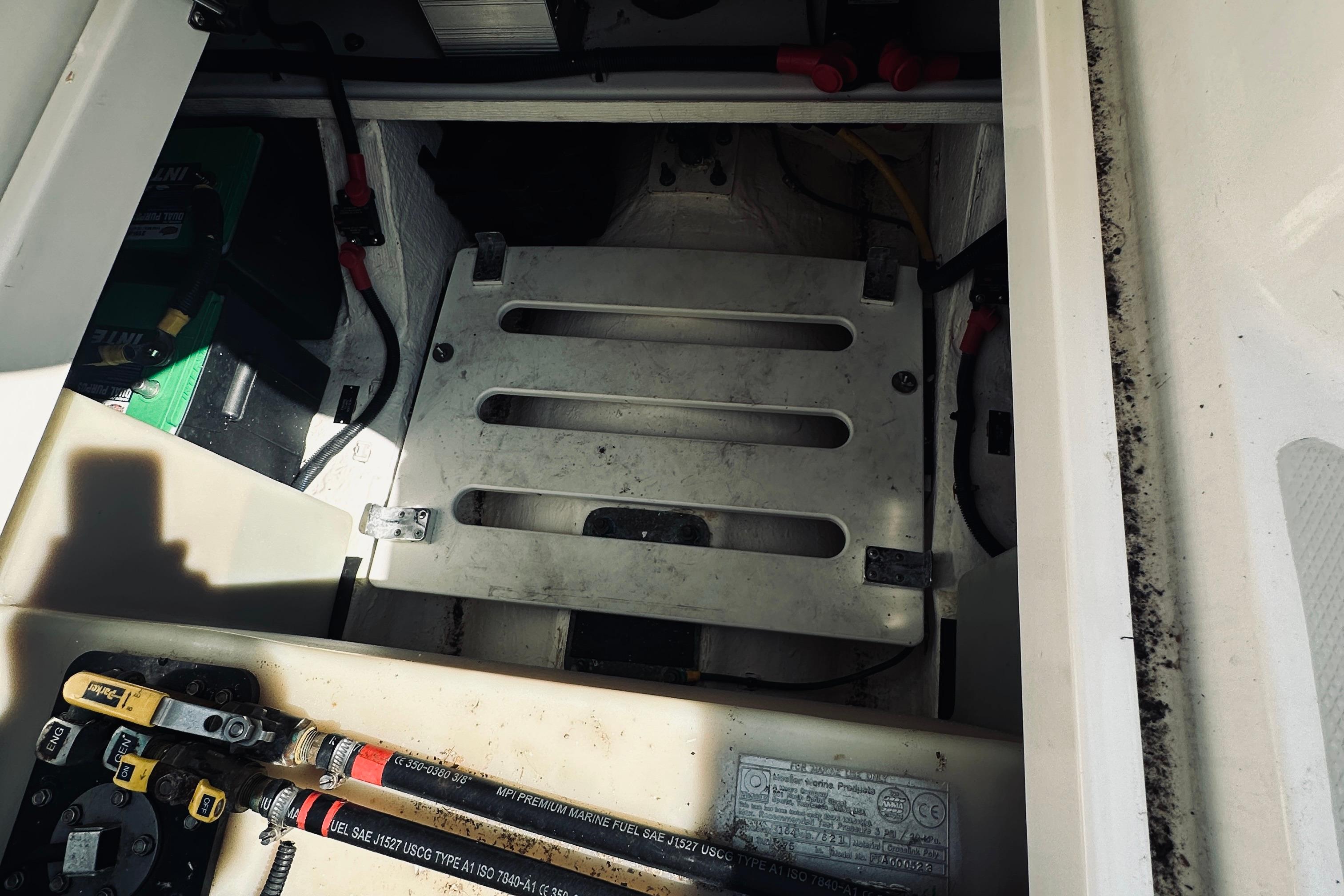 Engine compartment of a 2013 Back Cove 30 boat, showing battery and wiring.
