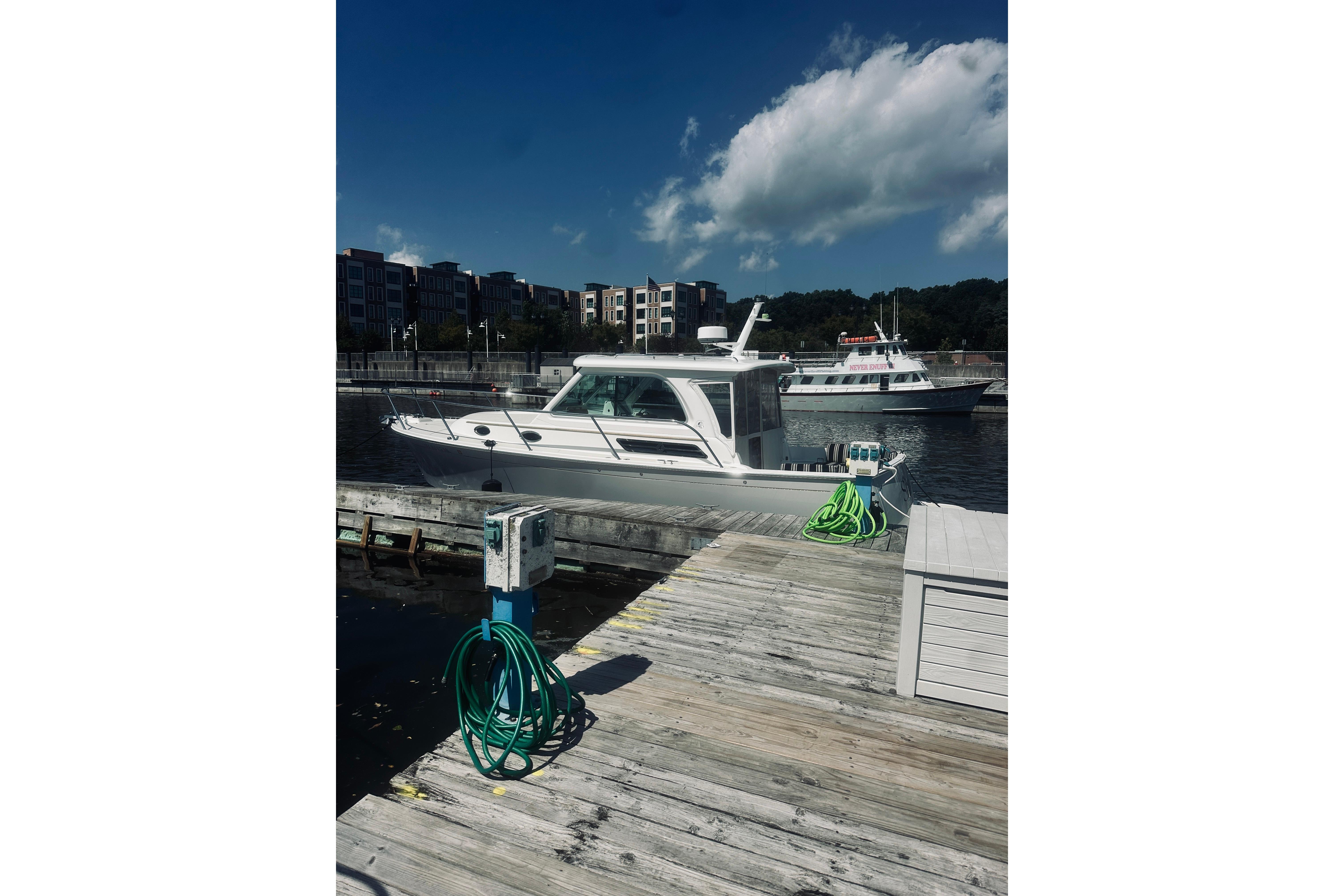 2013 Back Cove 30 boat docked at a marina with clear skies.