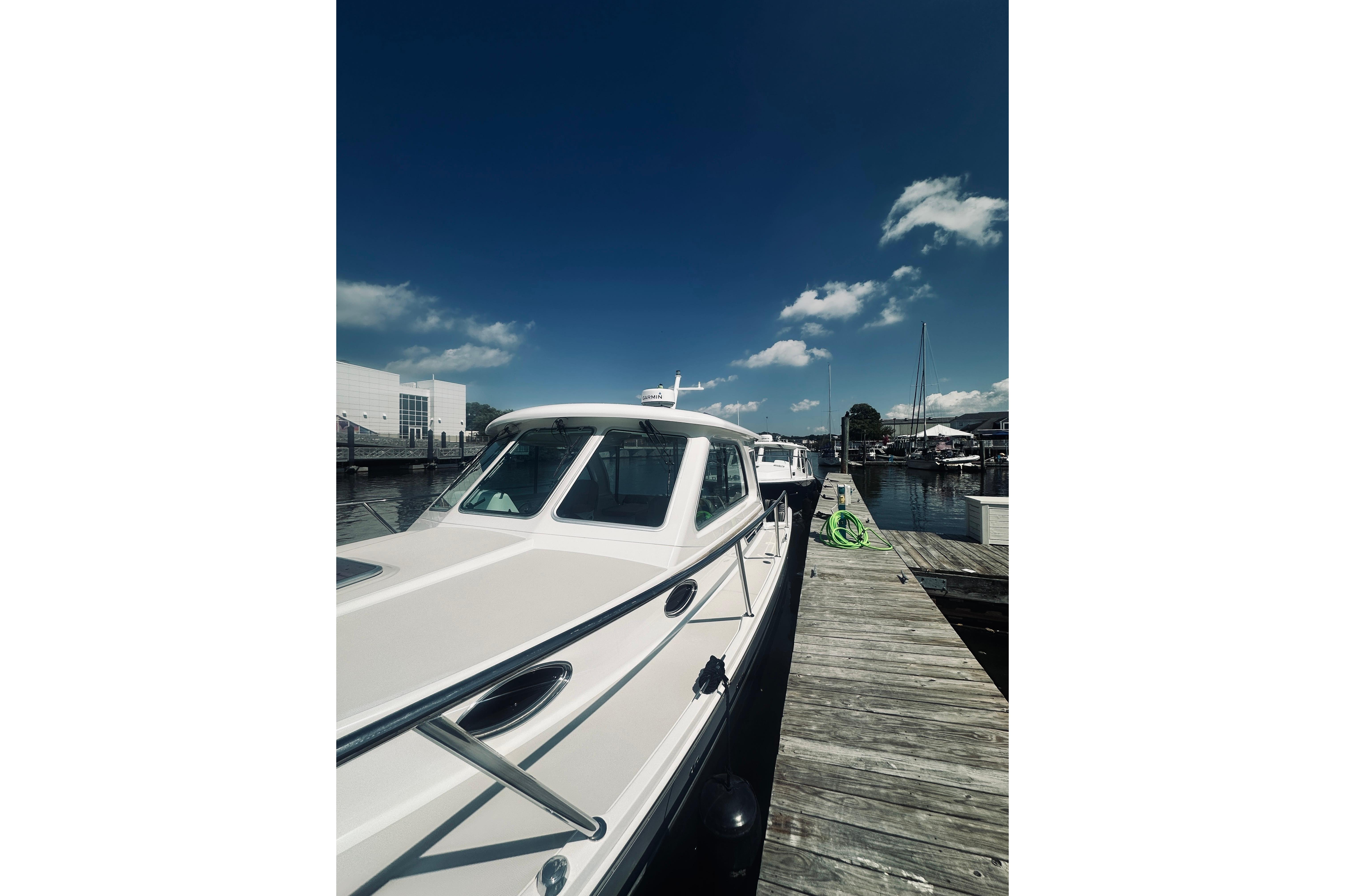 2013 Back Cove 30 boat docked at marina under clear blue sky.
