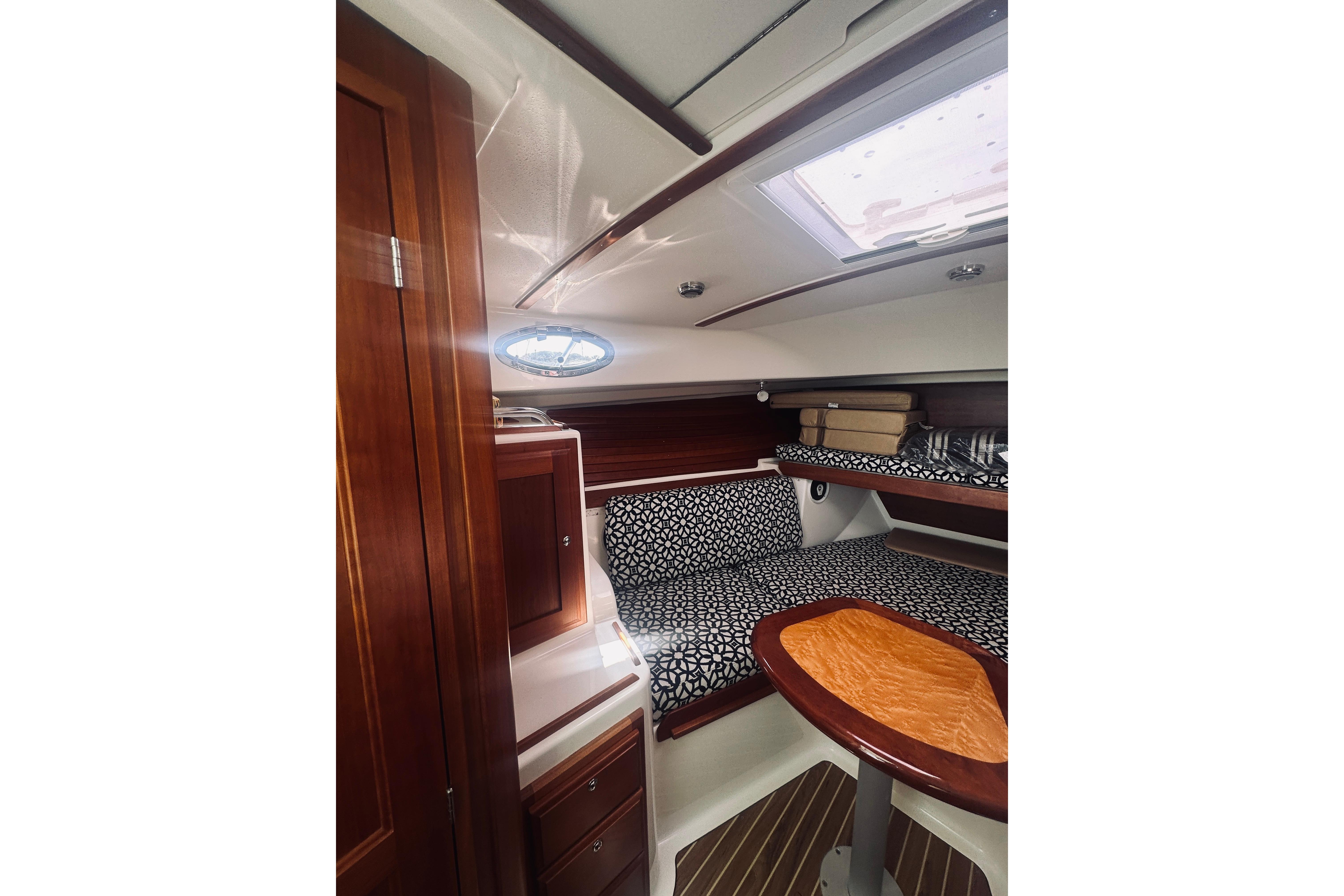 2013 Back Cove 30 cabin interior with wood finish and patterned cushions.