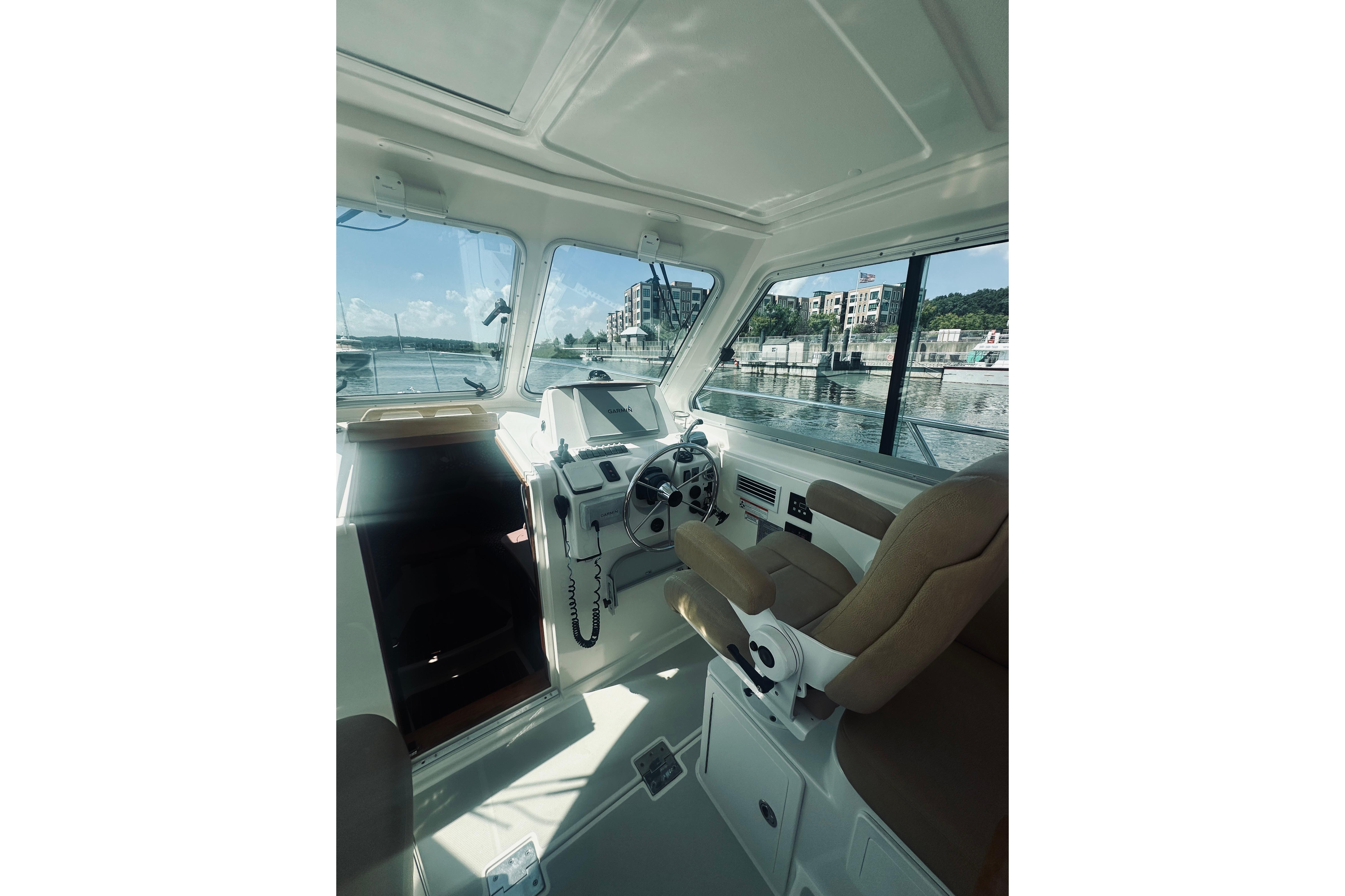 Interior view of 2013 Back Cove 30 boat, featuring helm and seating area.