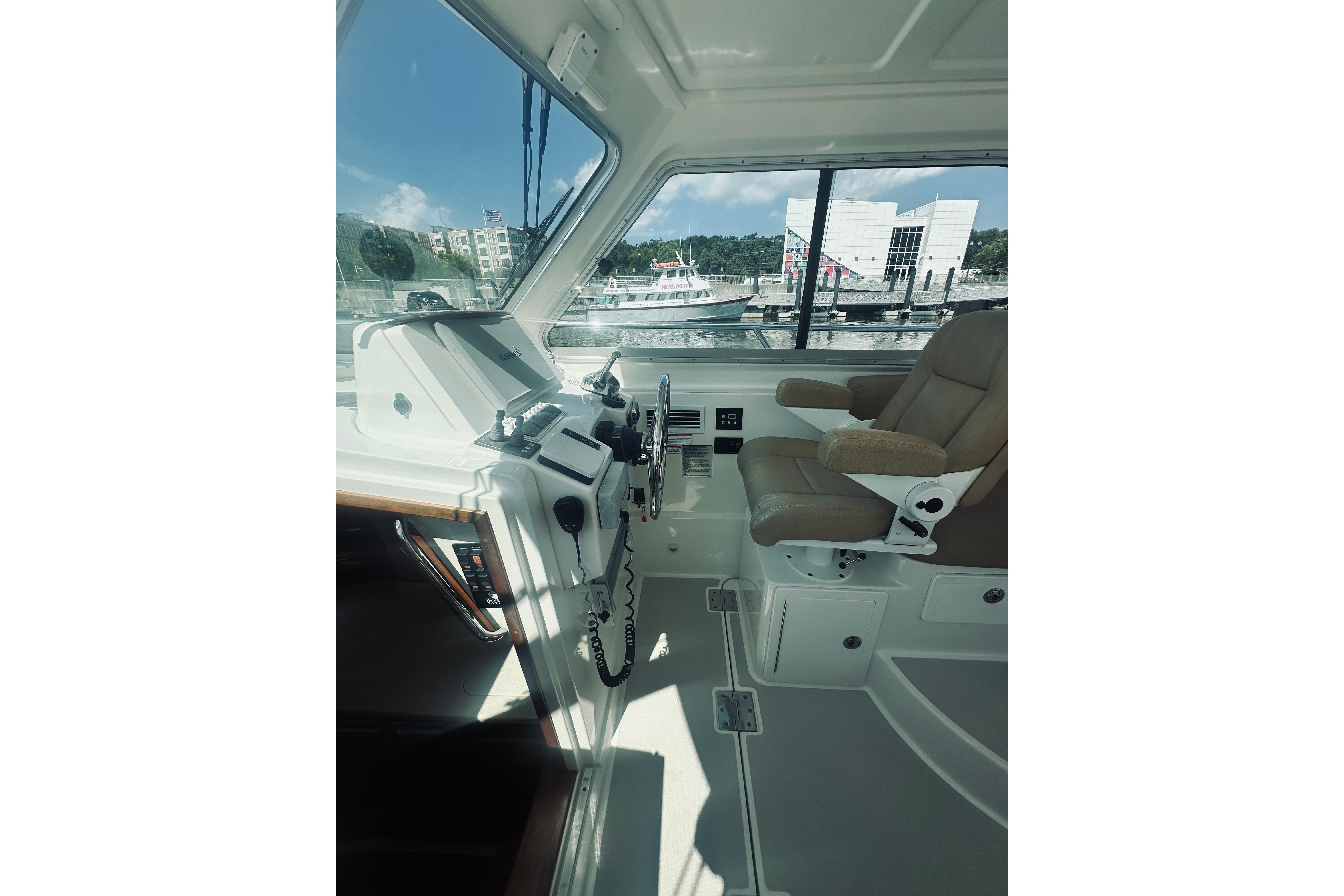 Interior of a 2013 Back Cove 30 boat, featuring helm and captainu0027s chair.