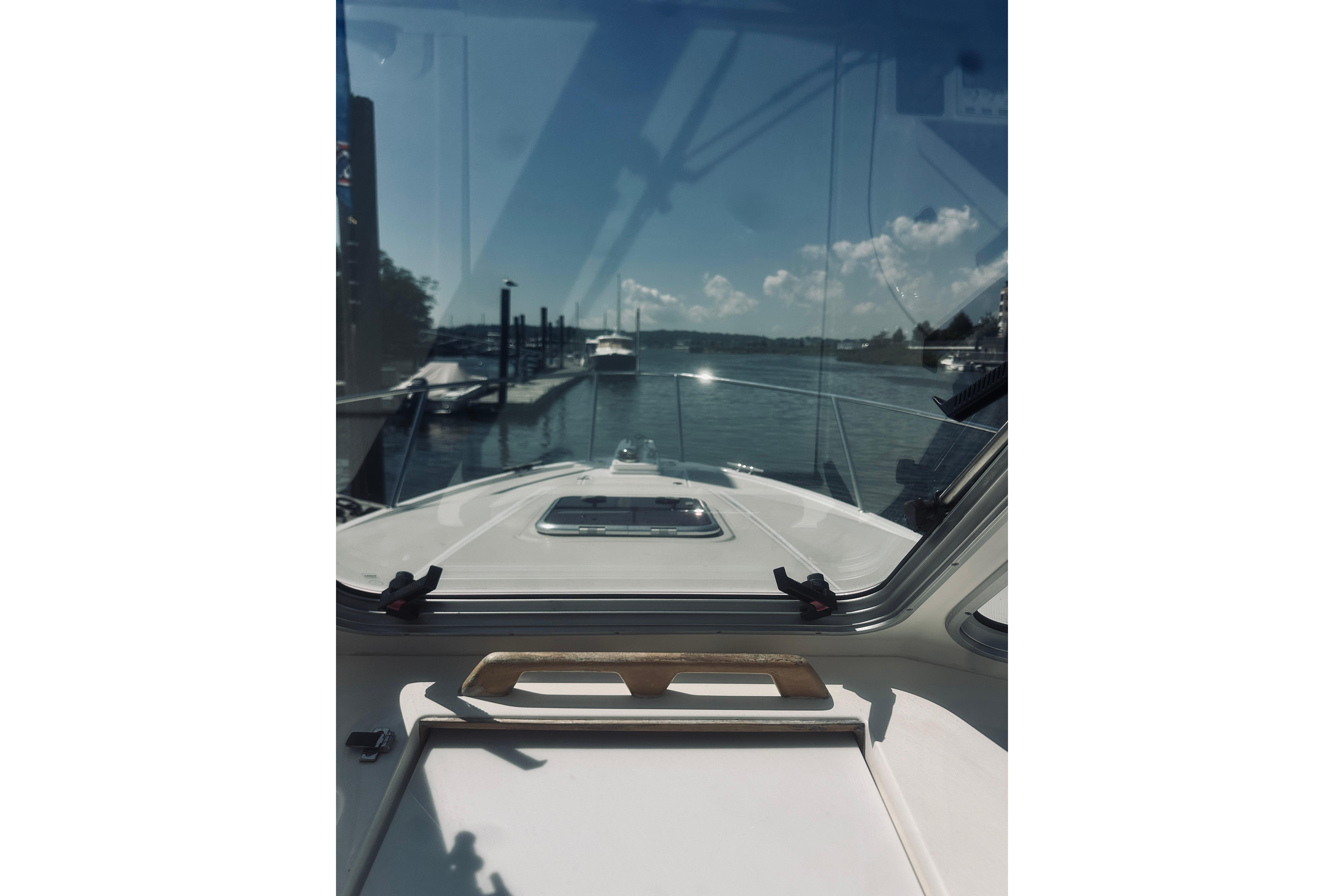 View from 2013 Back Cove 30 boat cockpit, overlooking marina and calm waters.