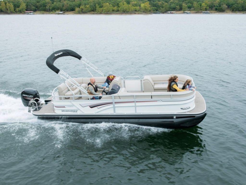 2023 Ranger 220C pontoon boat cruising on a lake with passengers.