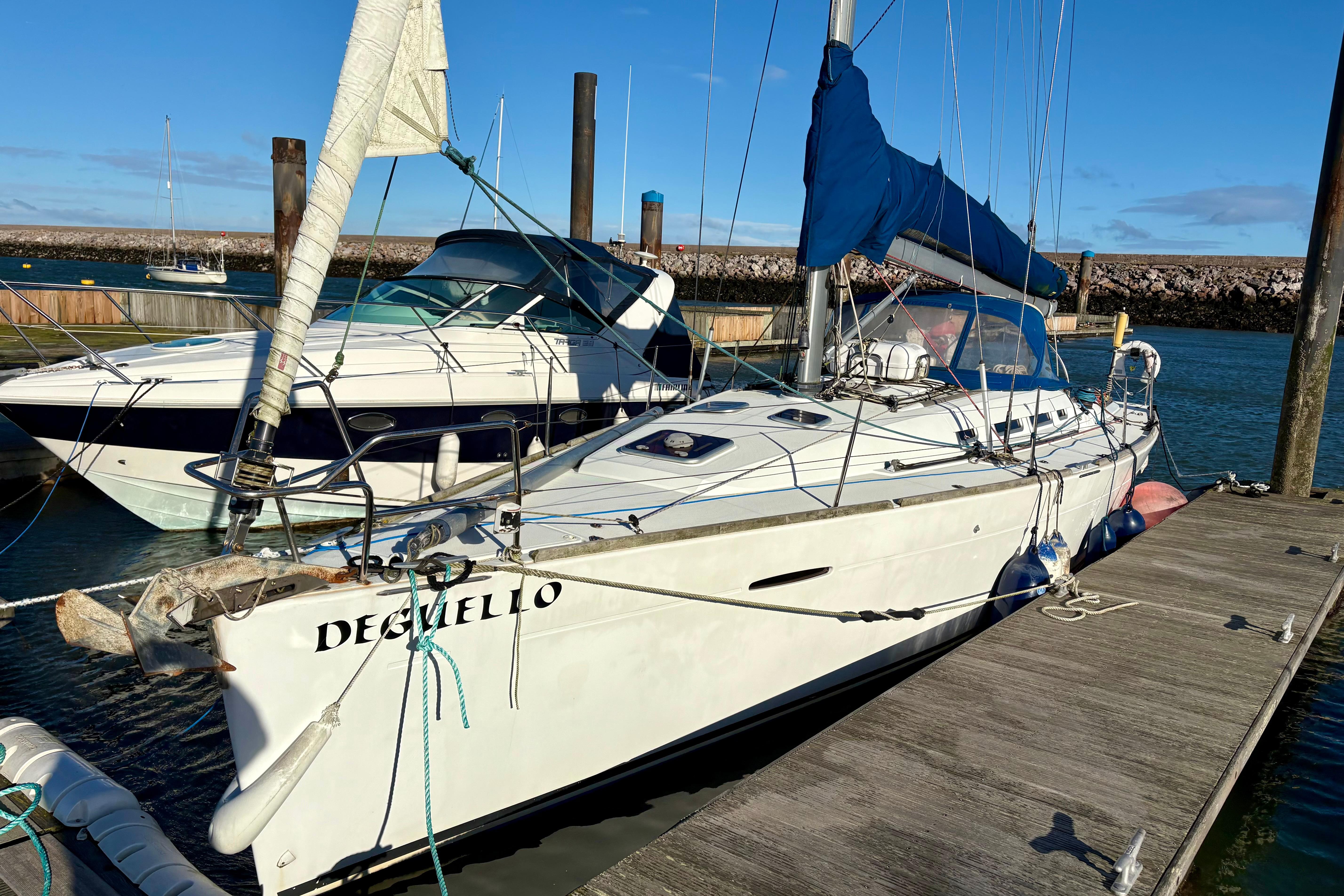 Sailboat Beneteau First 40, 2011 model, docked at marina under clear blue sky.