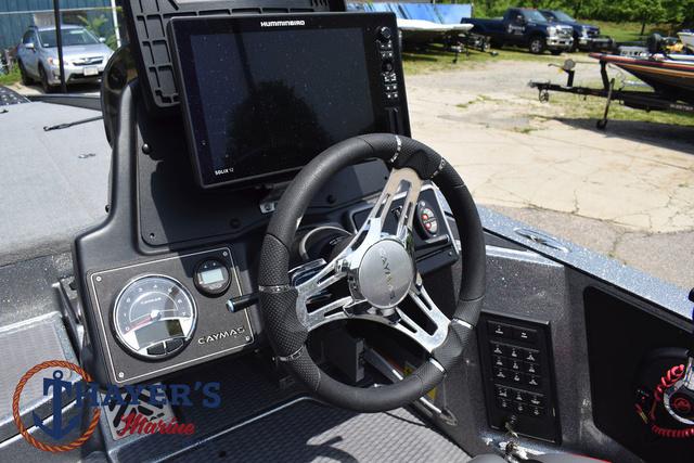 2023 Caymas CX20 Pro boat dashboard with steering wheel and electronic display.