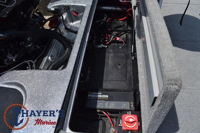 2023 Caymas CX20 Pro boat battery compartment with wiring and charger, Thayer's Marine logo visible.